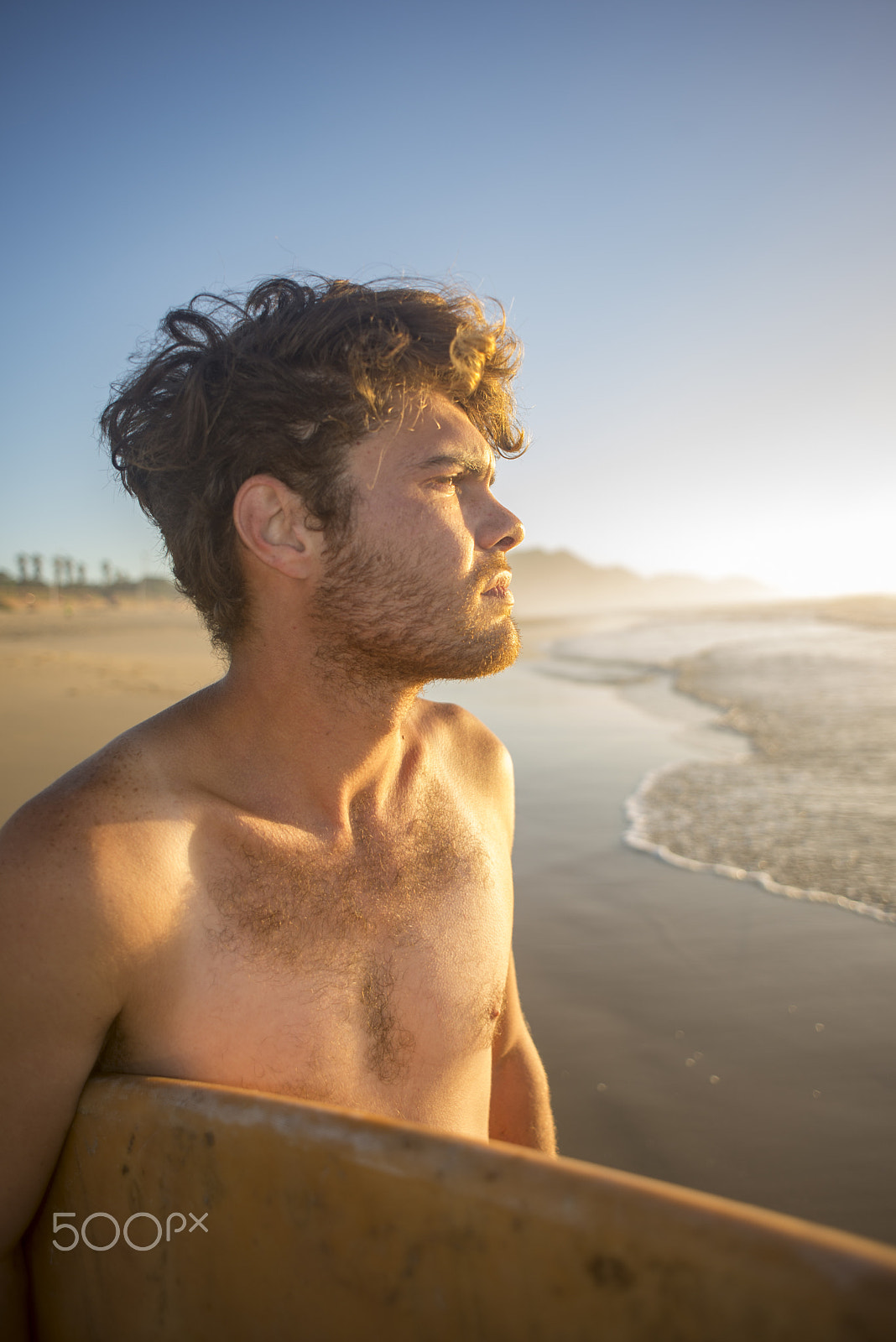 Nikon D600 + Nikon AF Nikkor 24mm F2.8D sample photo. Portrait of a surfer with board under arm by the ocean photography