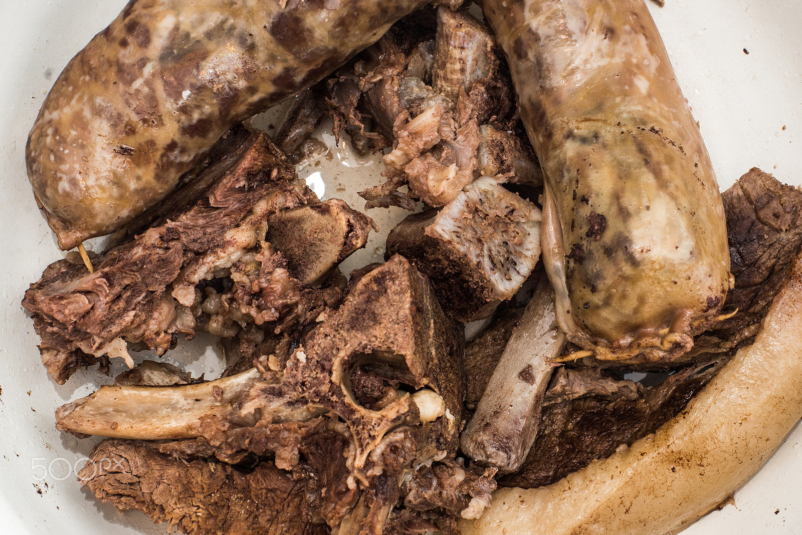 Nikon D610 + Nikon AF Nikkor 50mm F1.4D sample photo. Four raw rib-eye beaf steaks isolated on white background photography