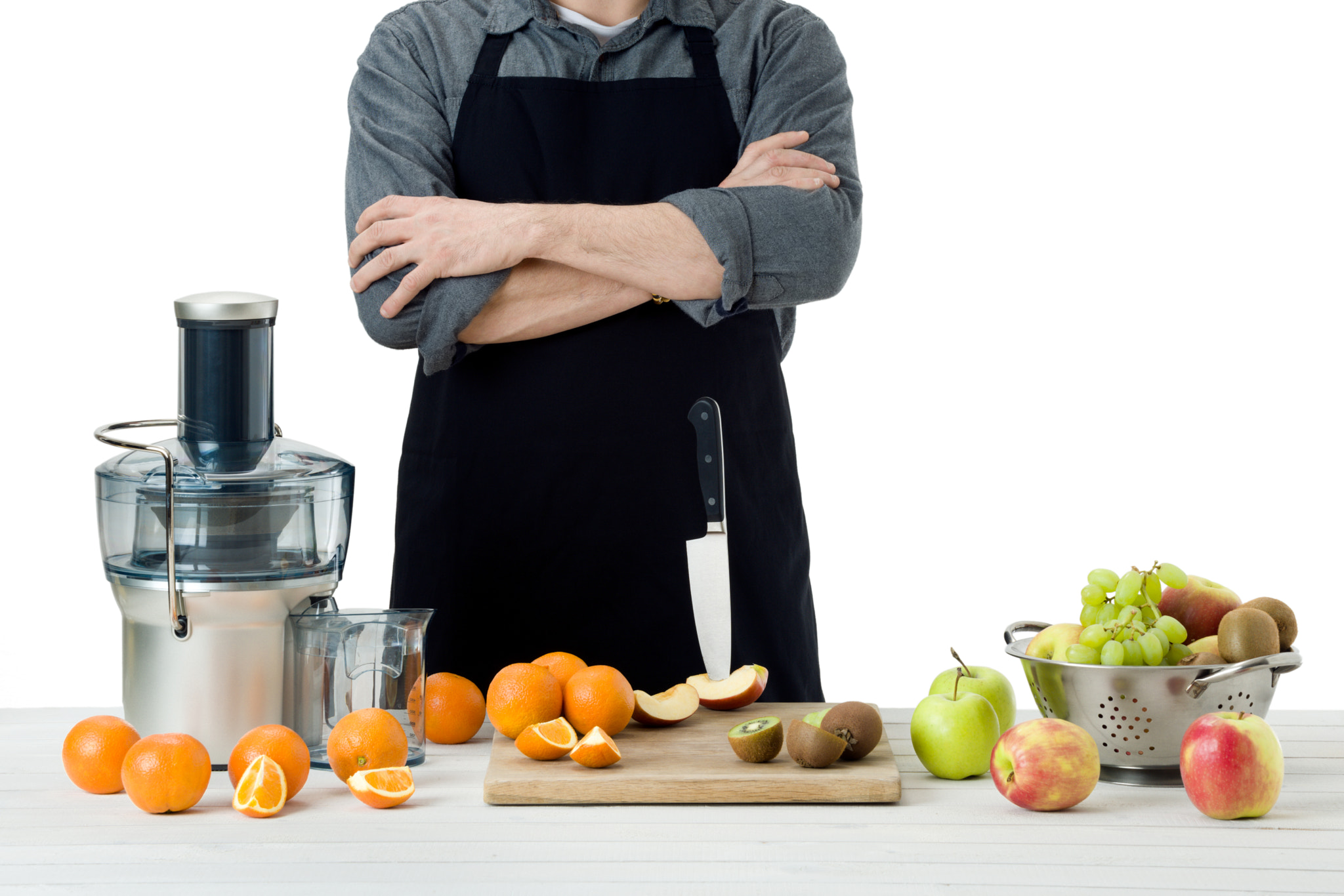 Nikon D810 sample photo. Anonymous man wearing an apron, preparing freshly made fruit juice, using modern electric juicer,... photography