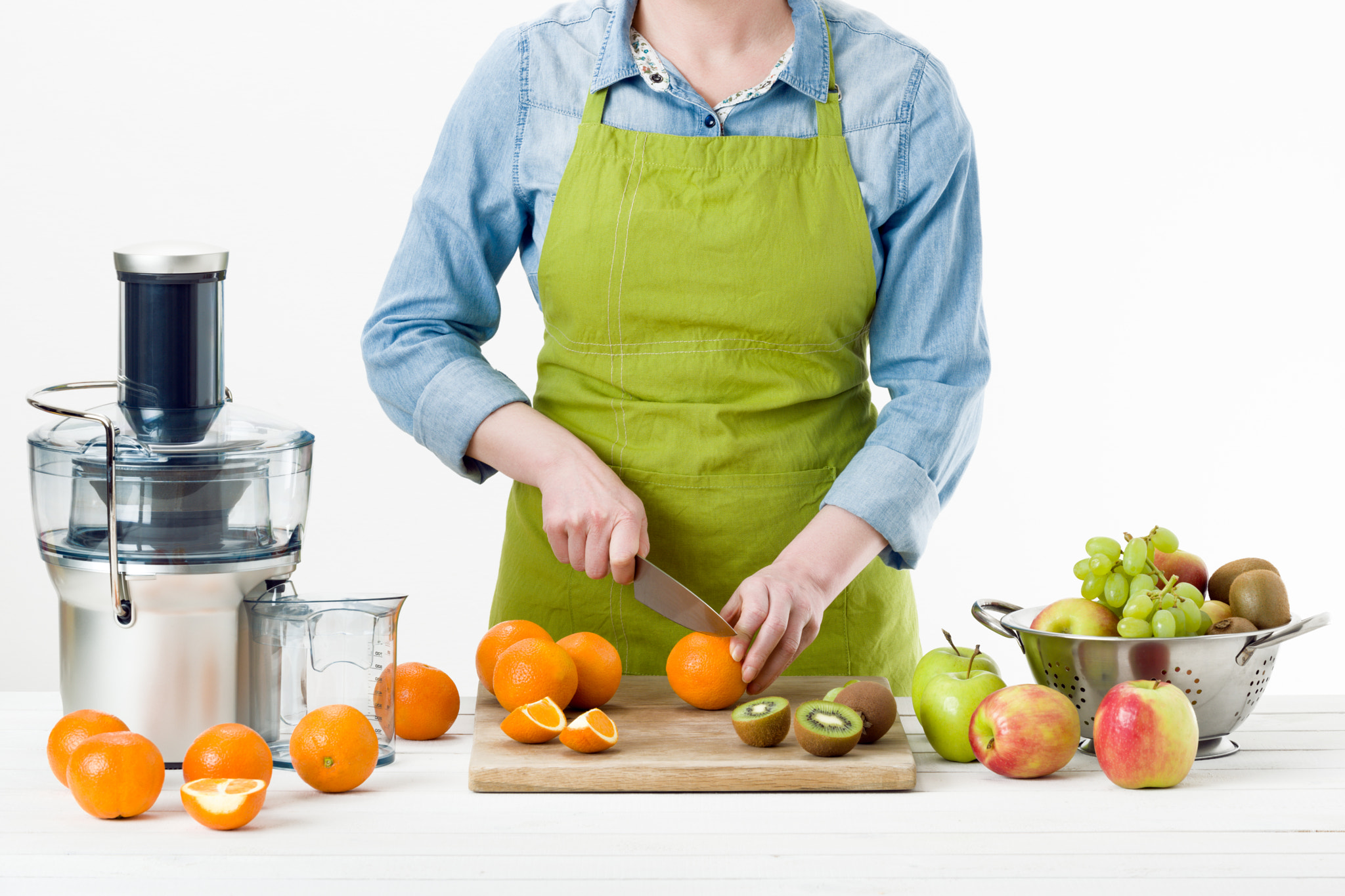 Nikon D810 sample photo. Anonymous woman wearing an apron, preparing fresh fruit juice using modern electric juicer,... photography
