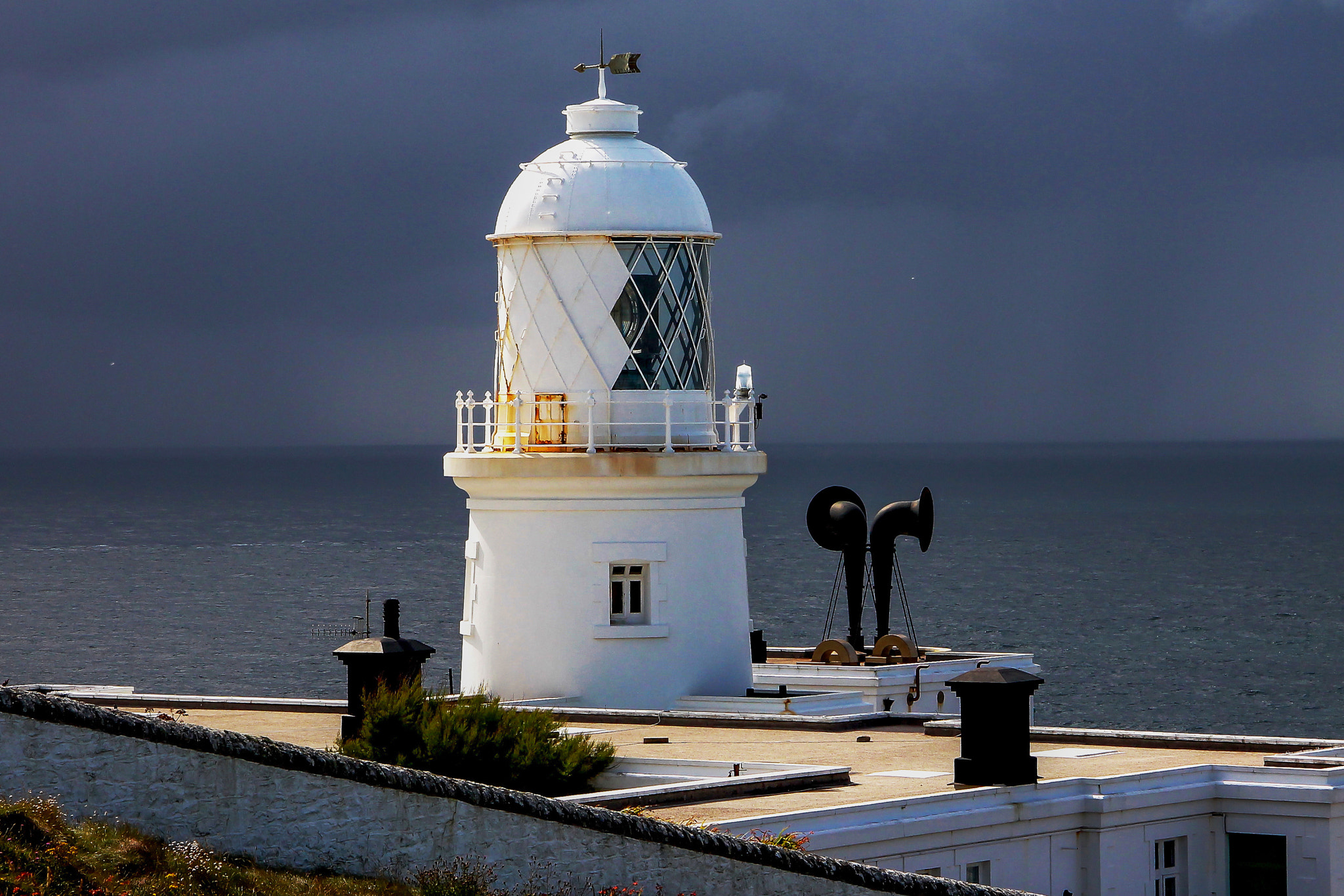 Canon EF-S 17-85mm F4-5.6 IS USM sample photo. Pendeen cliffs lighthouse still lit by sun before the rain moved in from the sea cornwall august photography