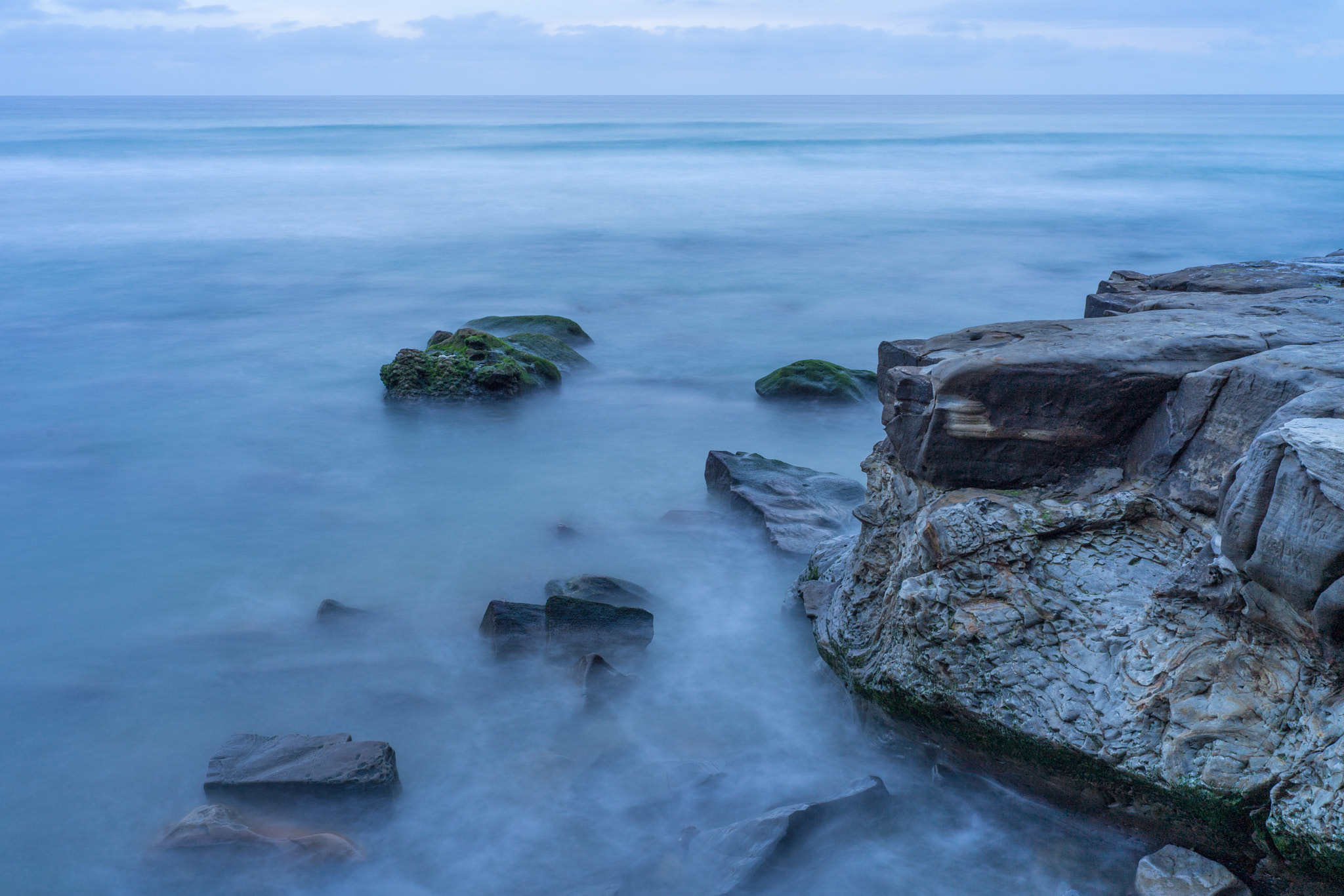 E 35mm F2 sample photo. Rocks and the sea photography