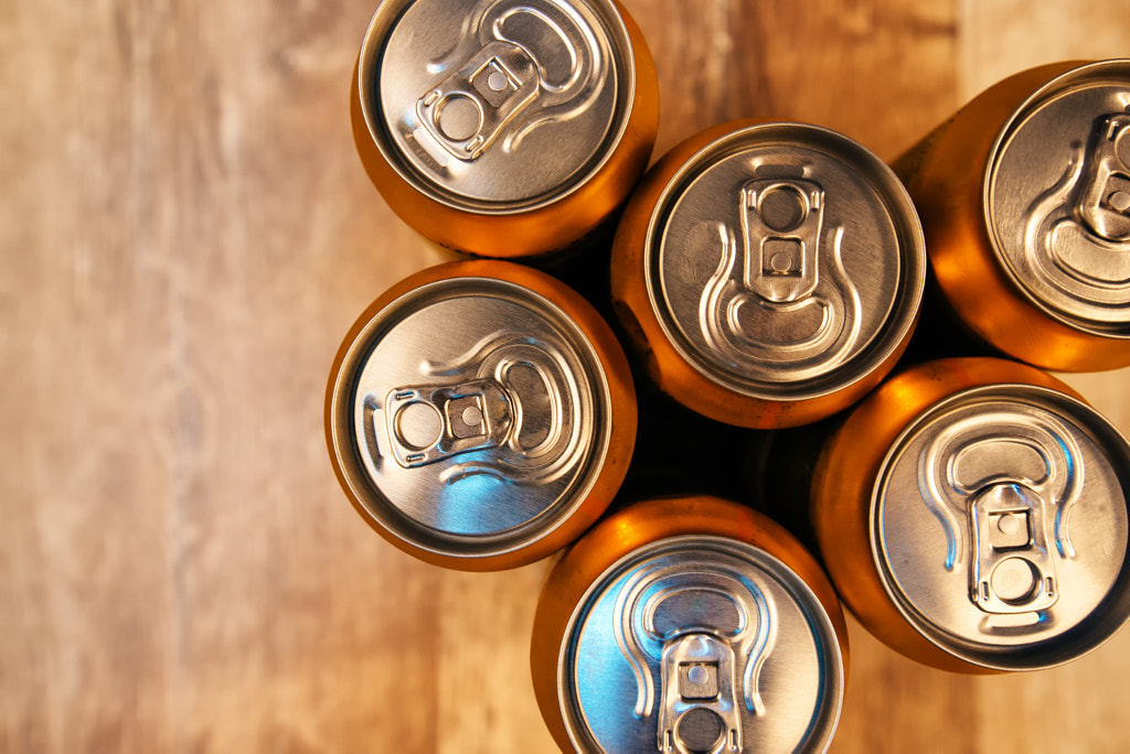 Beer cans on rustic wooden table top view by Igor Stevanovic on 500px.com