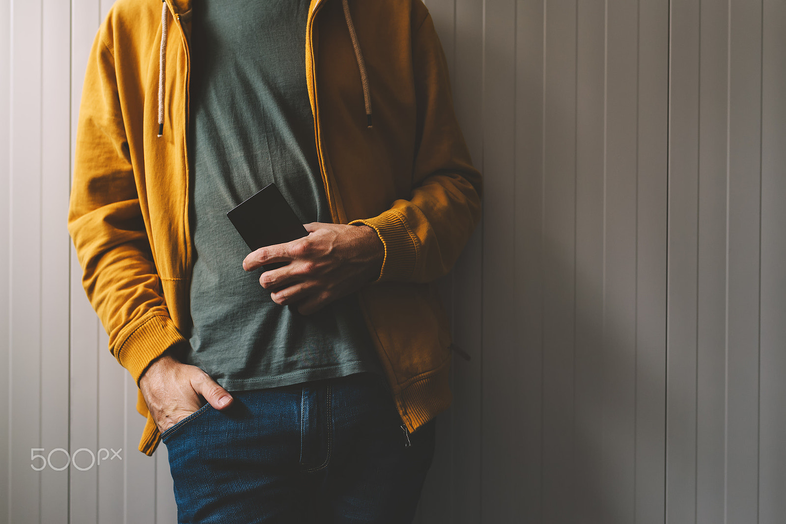 Nikon D600 + Sigma 35mm F1.4 DG HSM Art sample photo. Casual young adult man posing with mobile phone in hand photography