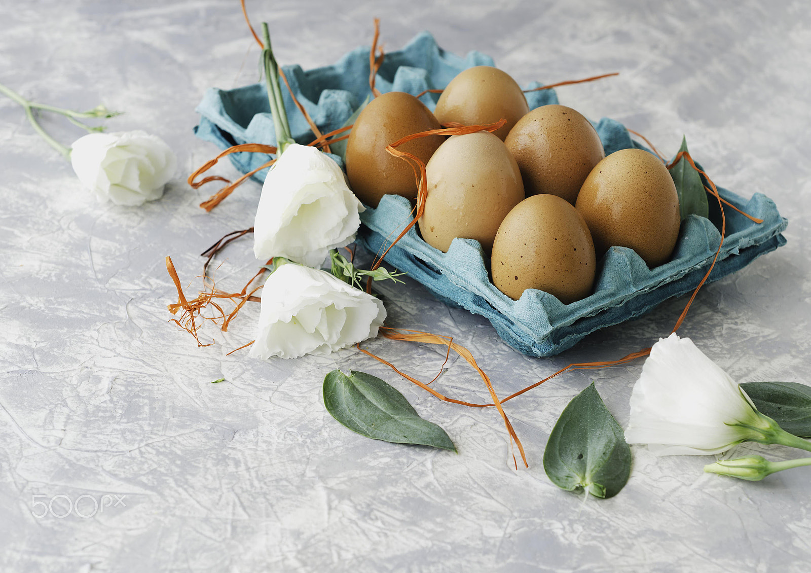Nikon AF-S DX Micro Nikkor 40mm F2.8 sample photo. Raw eggs in a carton for eggs with white flowers on a marble white table, ready for painting... photography