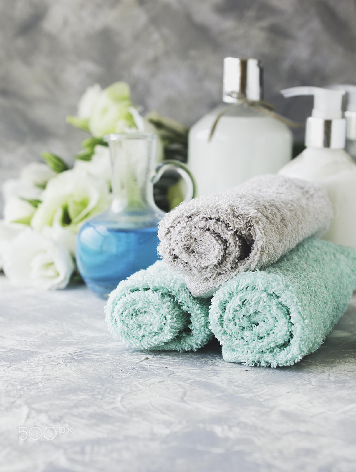 Nikon AF-S DX Micro Nikkor 40mm F2.8 sample photo. Spa set on a white marble table with a stack of towels, selective focus photography