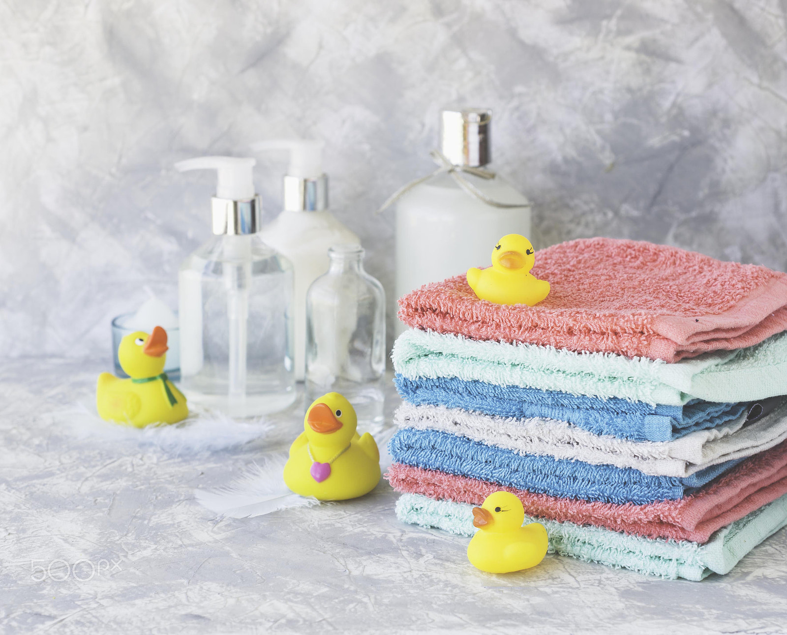 Nikon AF-S DX Micro Nikkor 40mm F2.8 sample photo. Stack of towels with yellow rubber bath ducks on white marble background, space for text,... photography