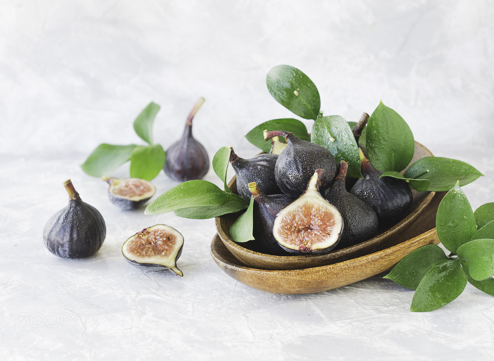 Nikon D7000 + Nikon AF-S DX Micro Nikkor 40mm F2.8 sample photo. Dark blue fresh figs in a wooden bowl on a white marble table, selective focus photography