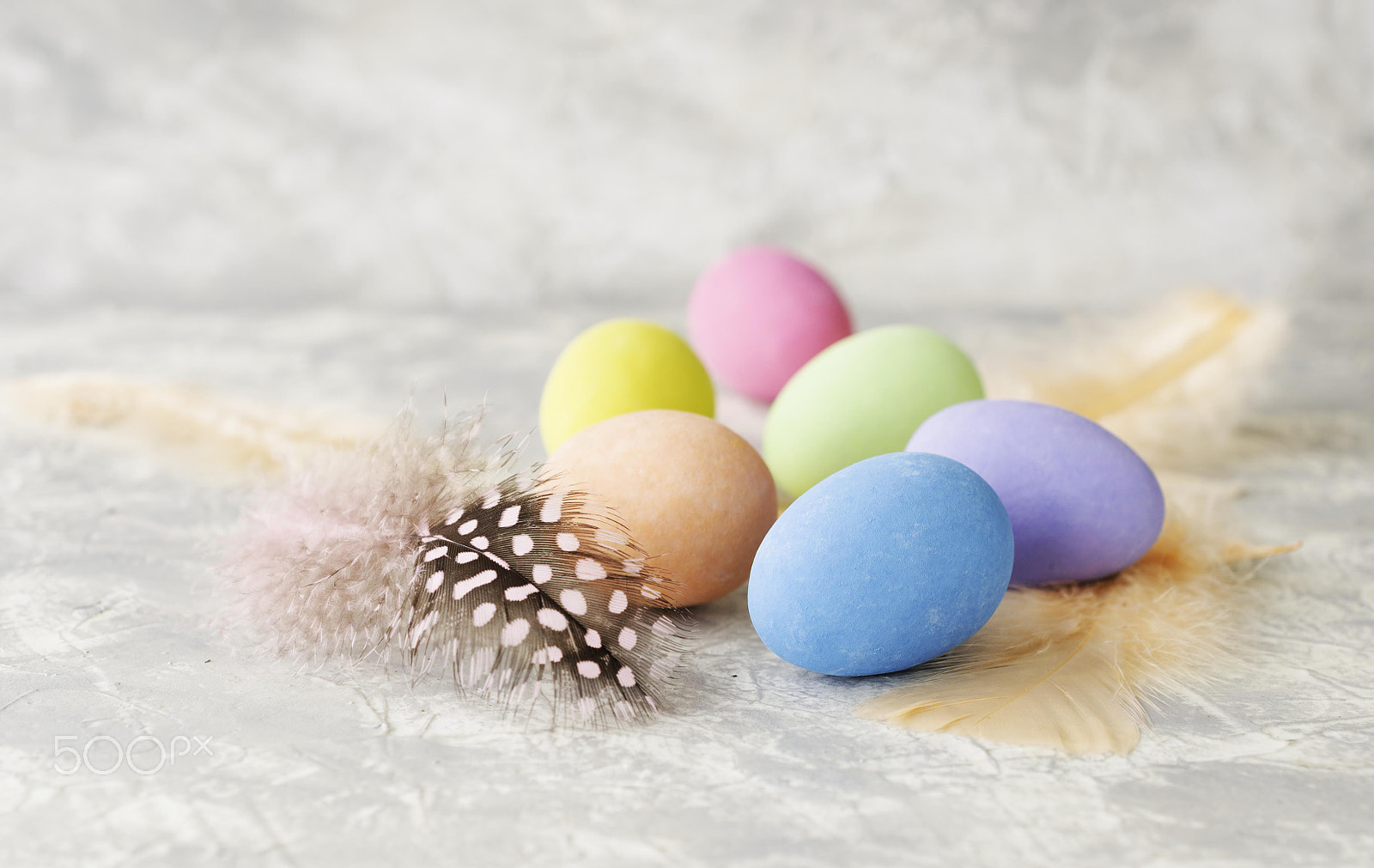 Nikon AF-S DX Micro Nikkor 40mm F2.8 sample photo. Colored easter eggs with feathers on a marble white table, selective focus photography