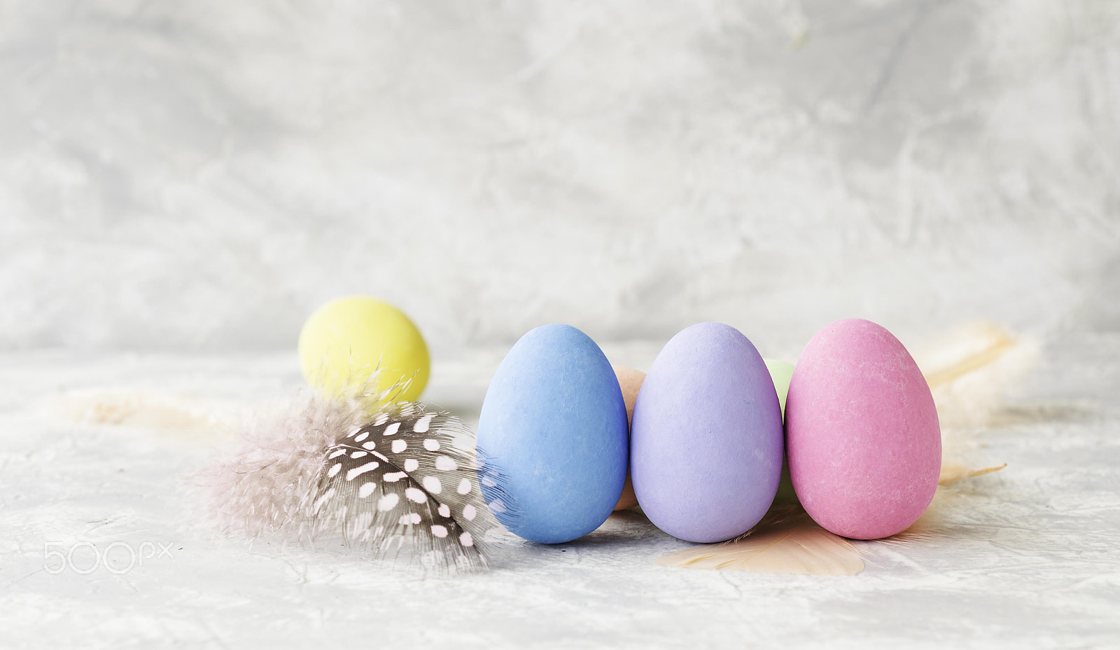 Nikon D7000 + Nikon AF-S DX Micro Nikkor 40mm F2.8 sample photo. Colored easter eggs with feathers on a marble white table, selective focus photography