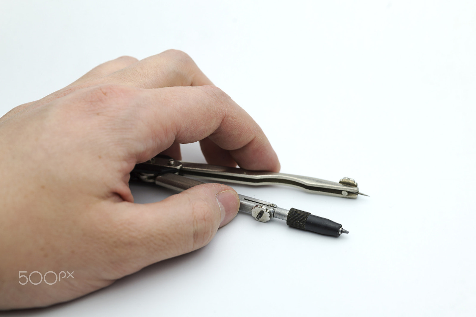 Nikon AF Micro-Nikkor 60mm F2.8D sample photo. Hand holds a pair of compasses. photography