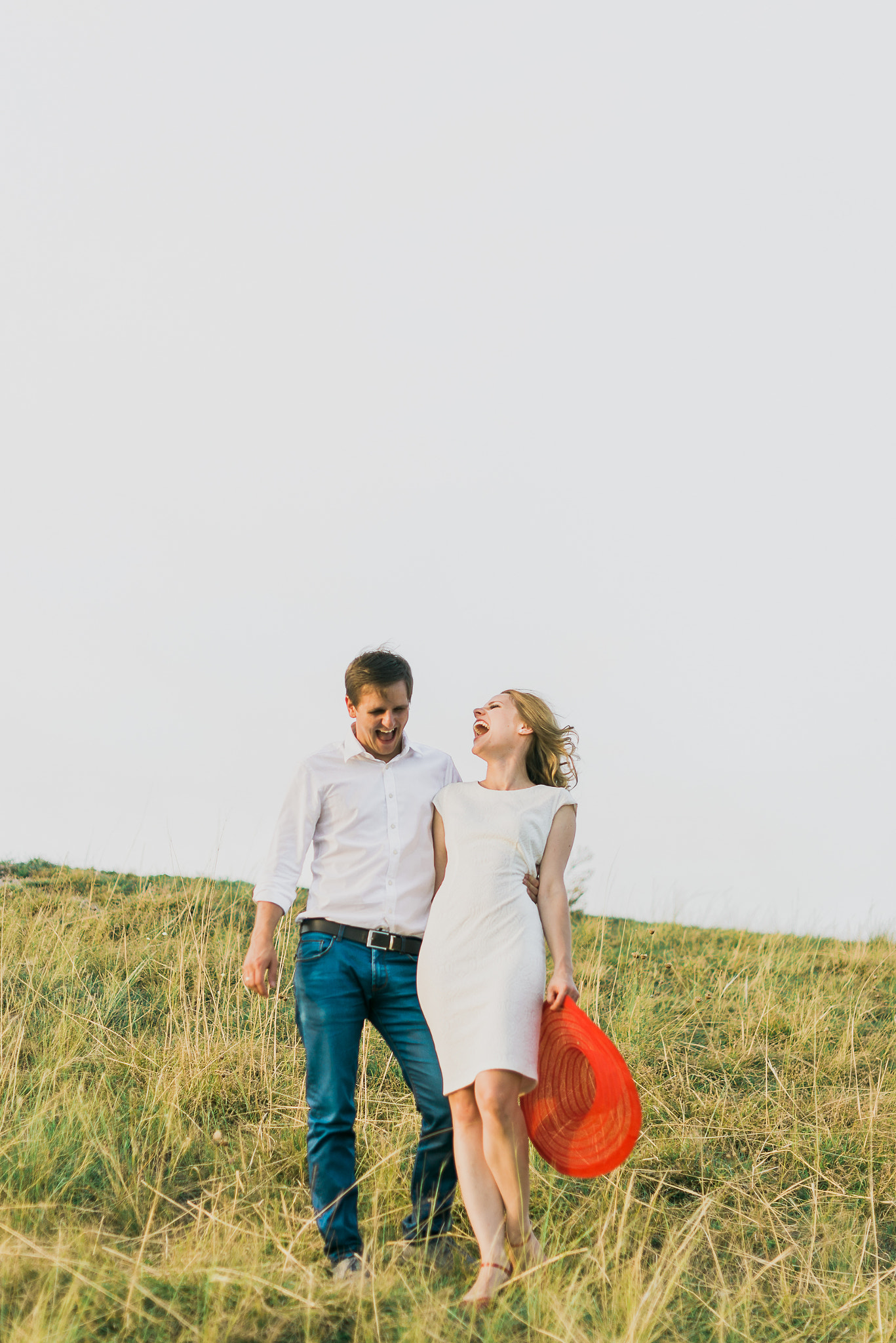 Nikon D600 + Nikon AF-S Nikkor 50mm F1.4G sample photo. Perfect match couple hugging on meadows holding strong and laughing out loud having fun photography