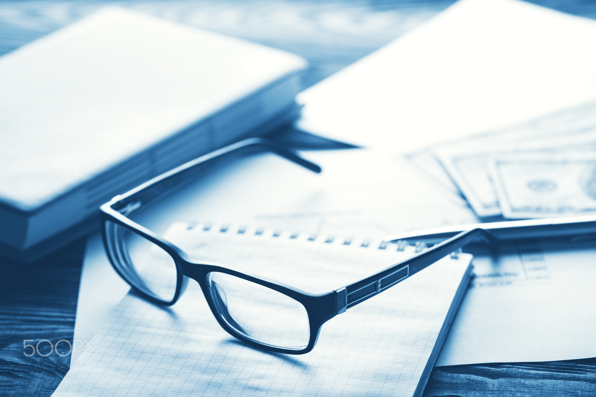 Business concept with glasses, hundred dollar bills and a diary