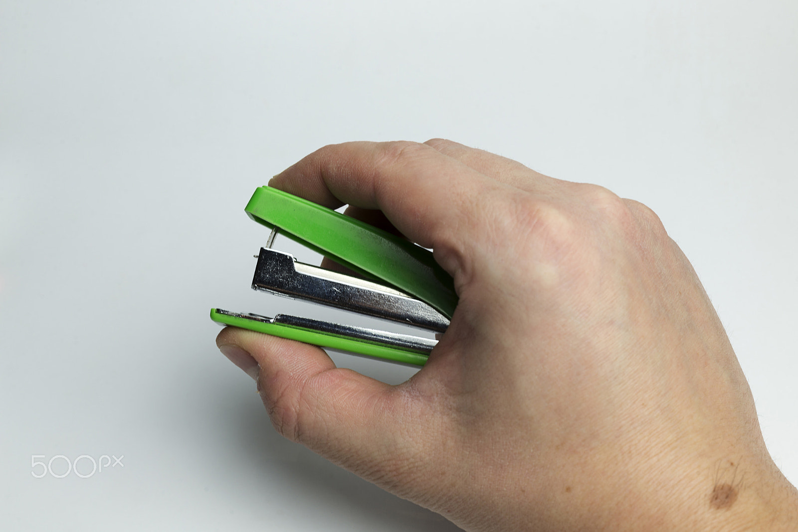 Nikon D600 + Nikon AF Micro-Nikkor 60mm F2.8D sample photo. Hand on a white background holding a stapler. photography