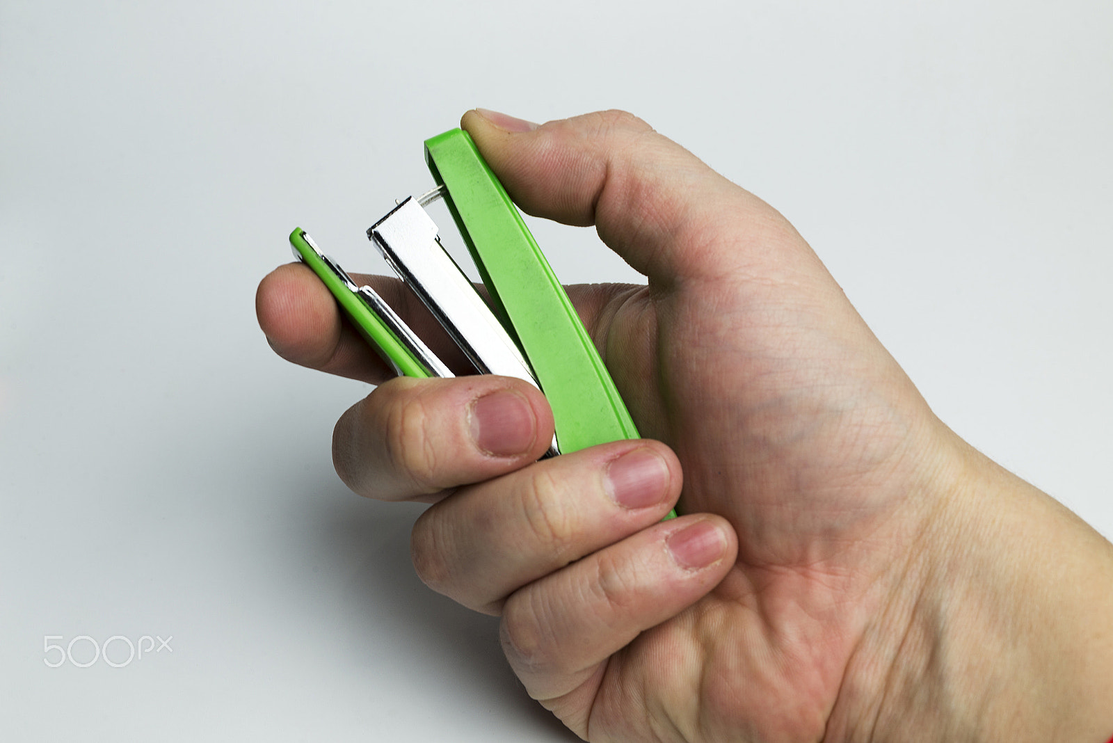 Nikon D600 + Nikon AF Micro-Nikkor 60mm F2.8D sample photo. Hand on a white background holding a stapler. photography