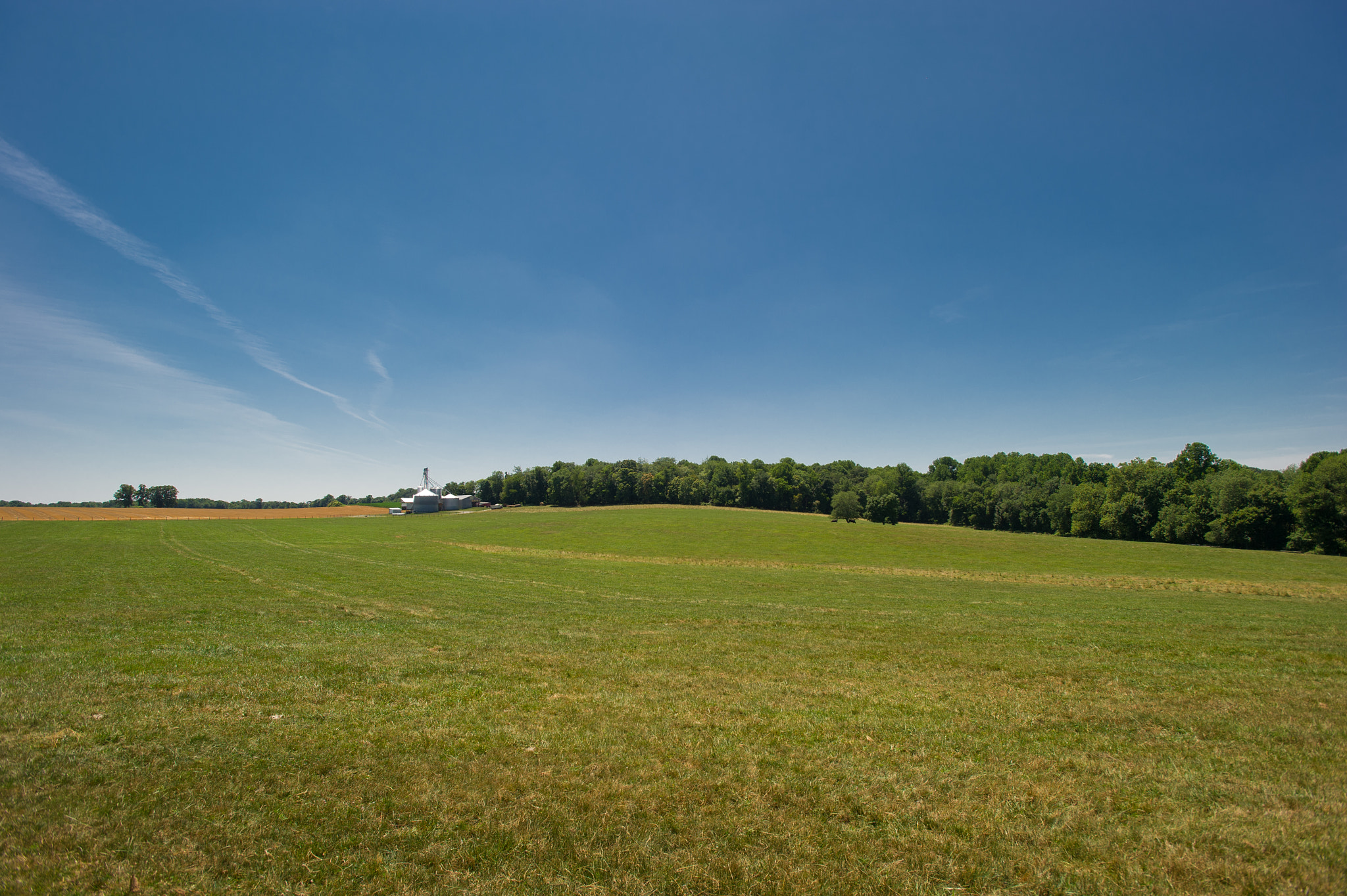 Nikon AF-S Nikkor 17-35mm F2.8D ED-IF sample photo. Grain elevator surrounded by wide open field photography