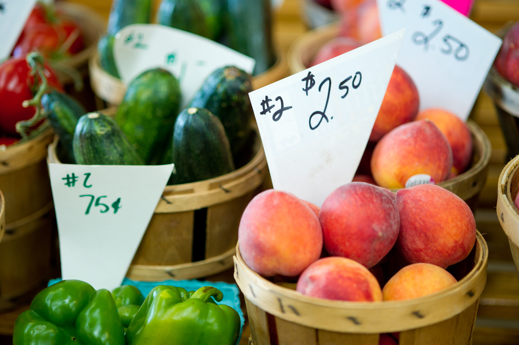 Nikon D3S sample photo. Crates of green peppers, cucumbers, peaches and tomatoes for sale at a farmer's market photography