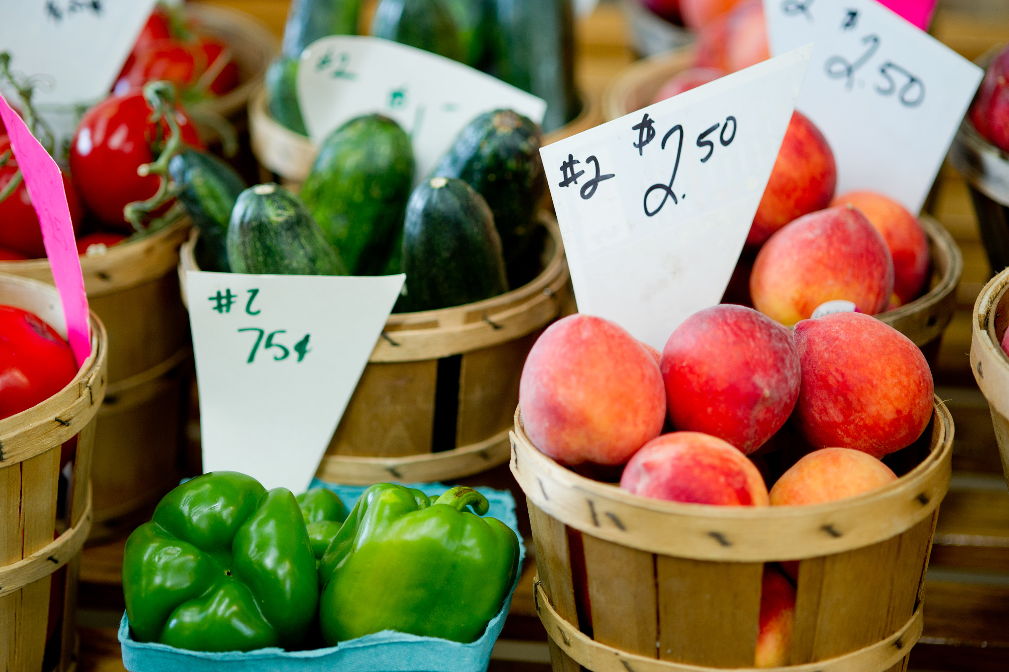Nikon D3S sample photo. Crates of green peppers, cucumbers, peaches and tomatoes at for sale at a farmer's market photography
