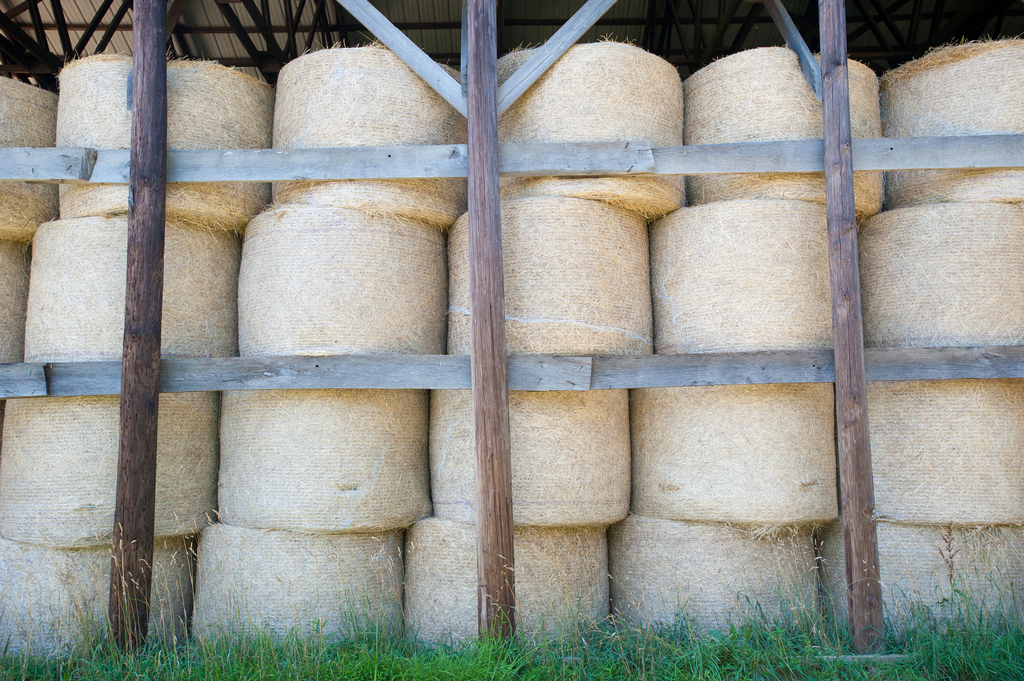 Nikon D700 + Nikon AF-S Nikkor 17-35mm F2.8D ED-IF sample photo. Hay bales stacked in barn photography