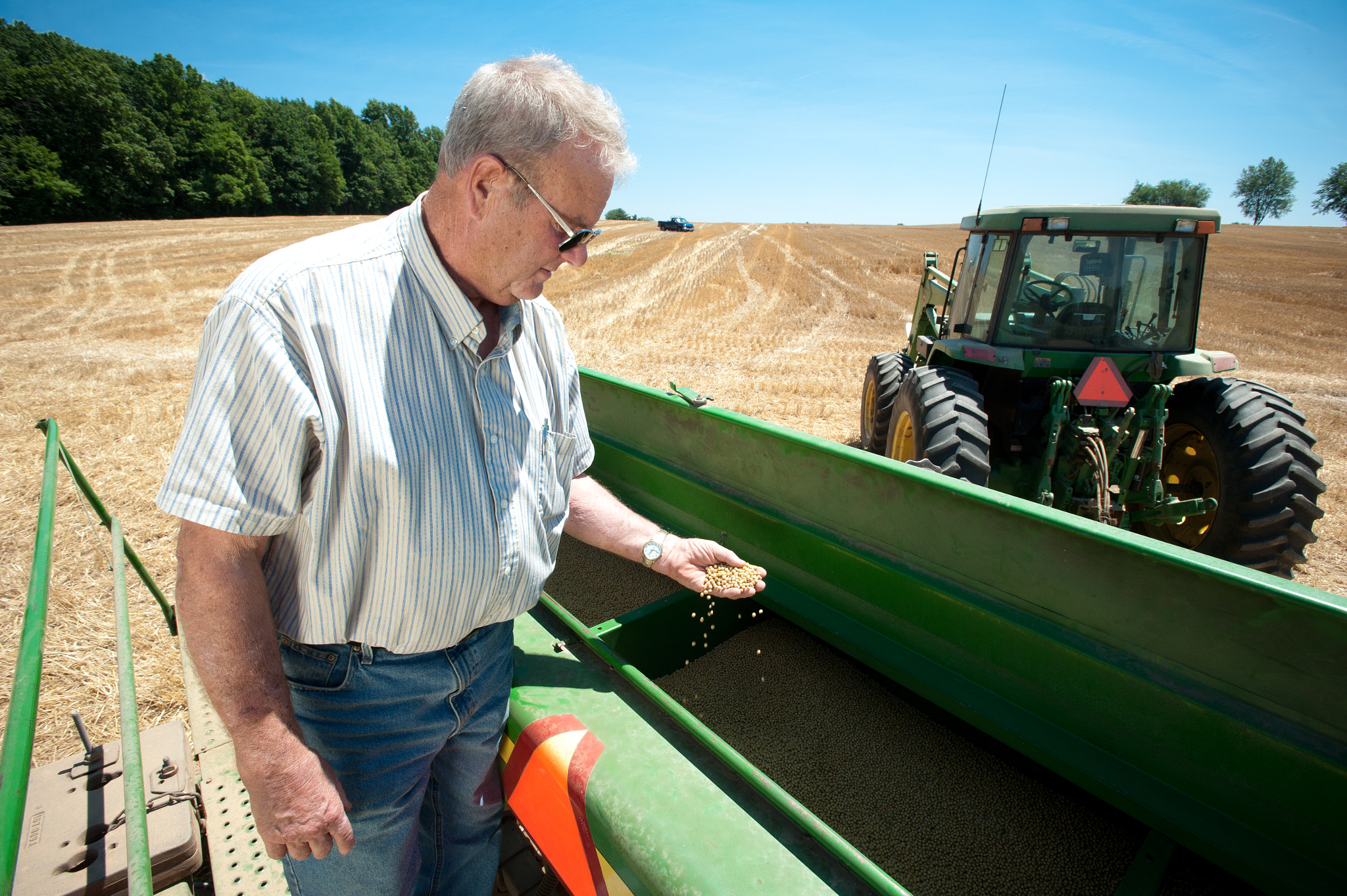 Nikon AF-S Nikkor 17-35mm F2.8D ED-IF sample photo. Farmer inspecting grain in combine photography