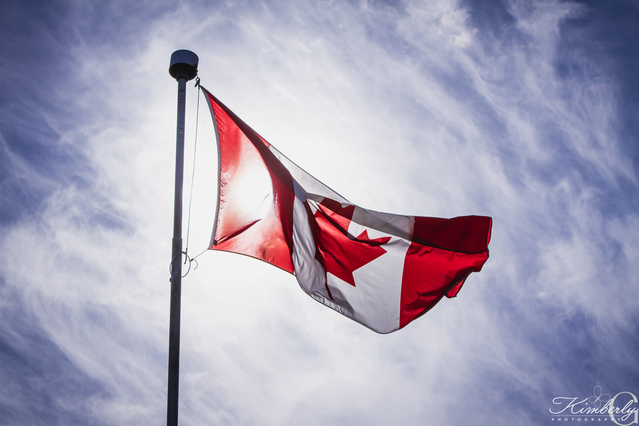 Sigma 70-200mm F2.8 EX DG OS HSM sample photo. Canadian flag with the sun behind it photography