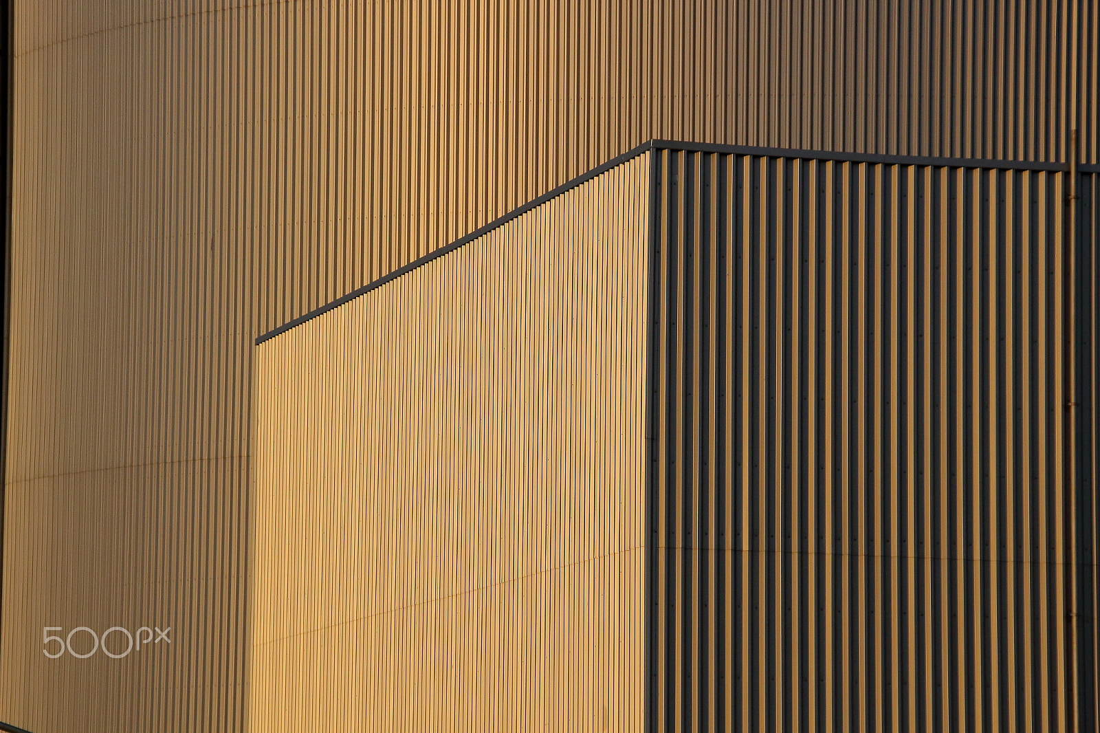 Sigma 18-200mm f/3.5-6.3 DC OS sample photo. Metal buildings in golden light photography