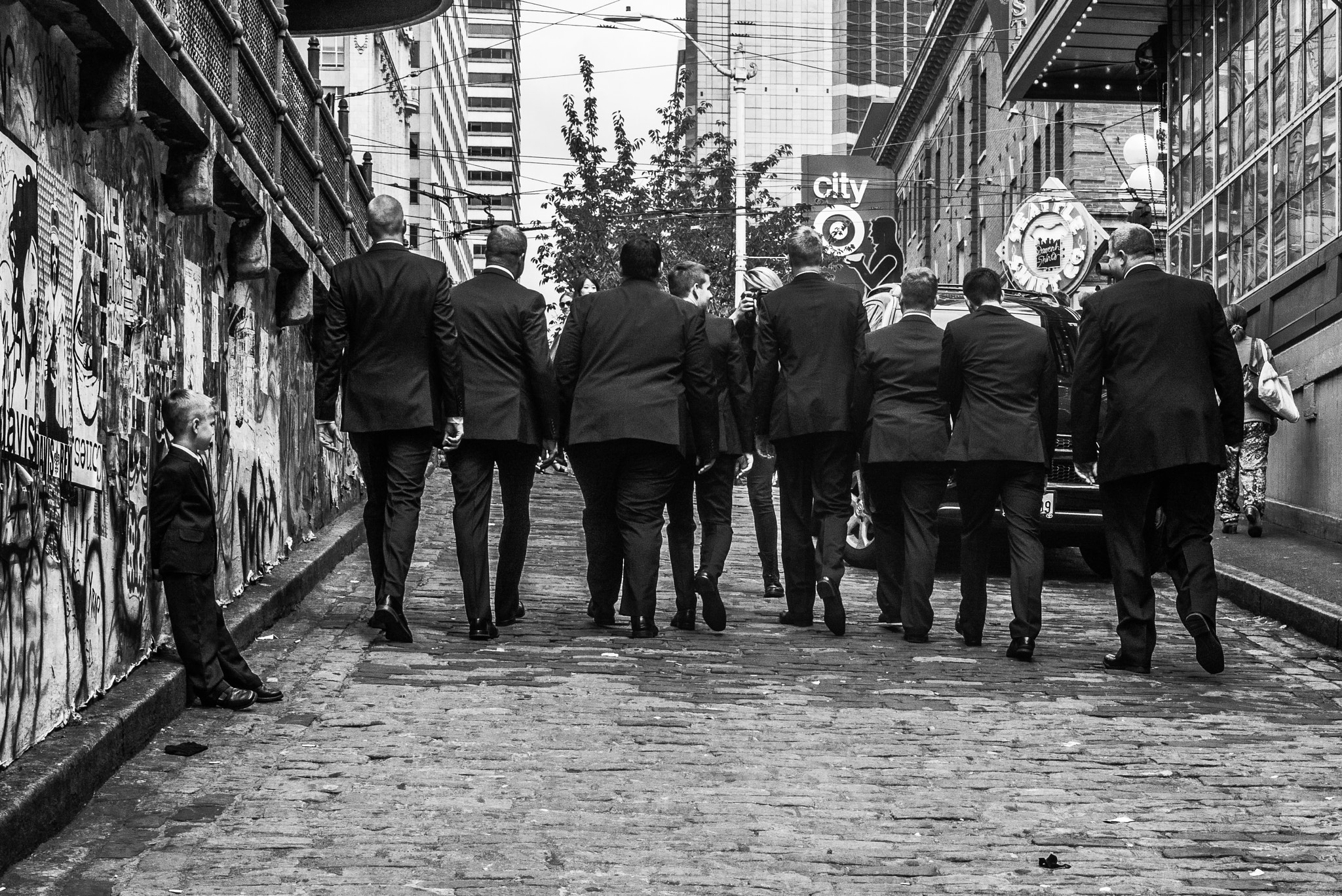 Leica Summilux-M 50mm F1.4 ASPH sample photo. Men in black.... ( and the kid ) photography