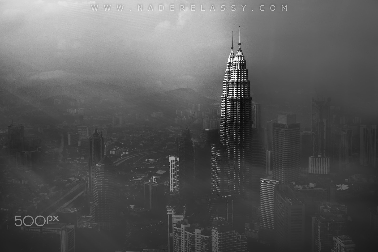 Sony E 18-200mm F3.5-6.3 OSS sample photo. Petronas towers in a foggy afternoon photography