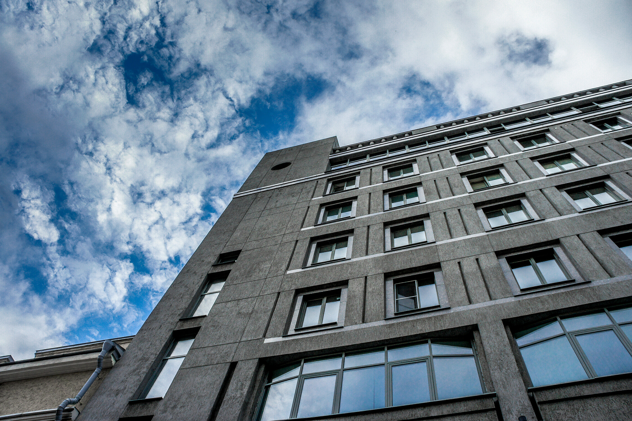 Sony Alpha NEX-3 sample photo. Clouds over office buildings photography