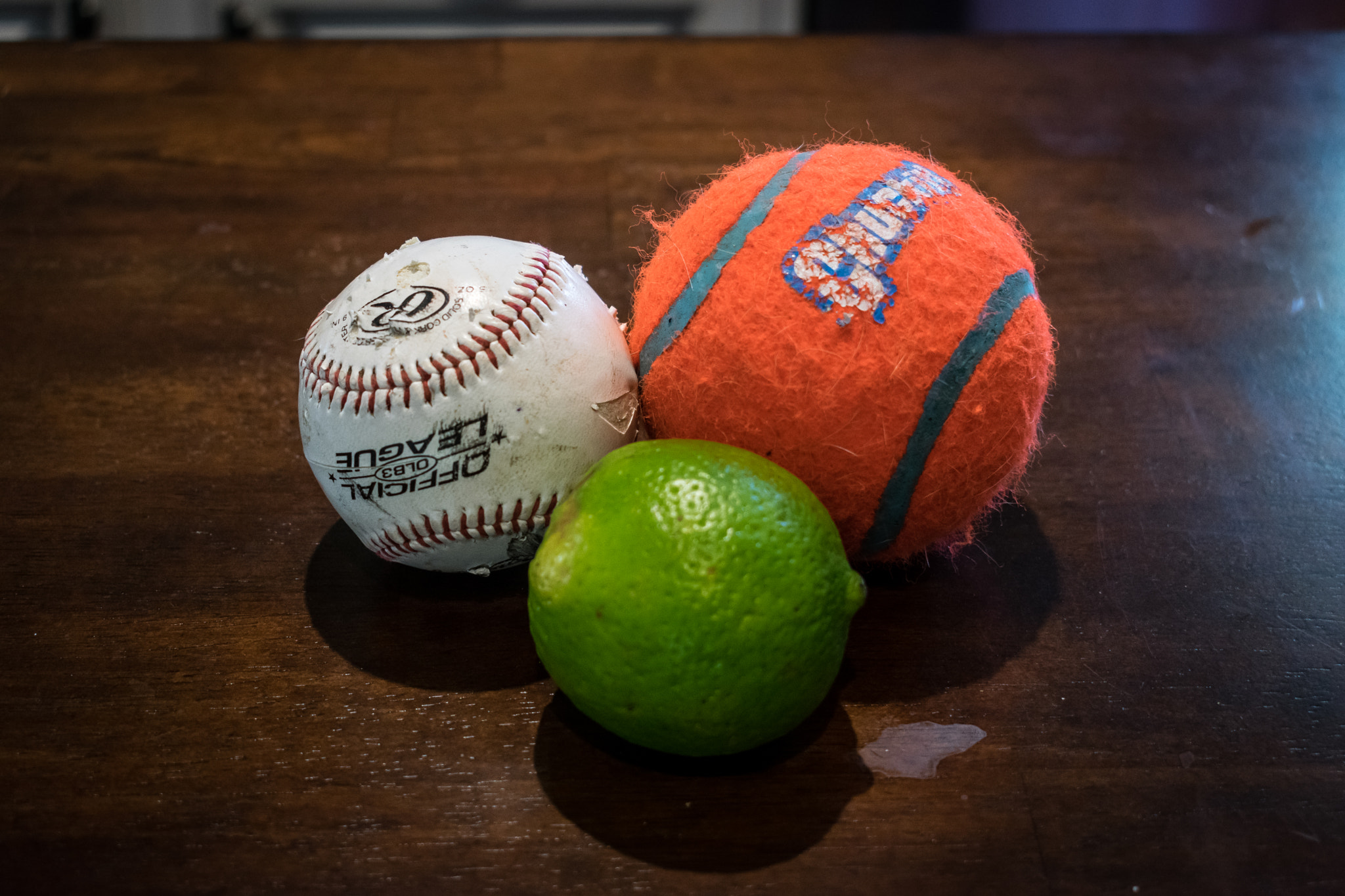 Nikon D3400 sample photo. A baseball, a lime and a giant orange tennis ball photography