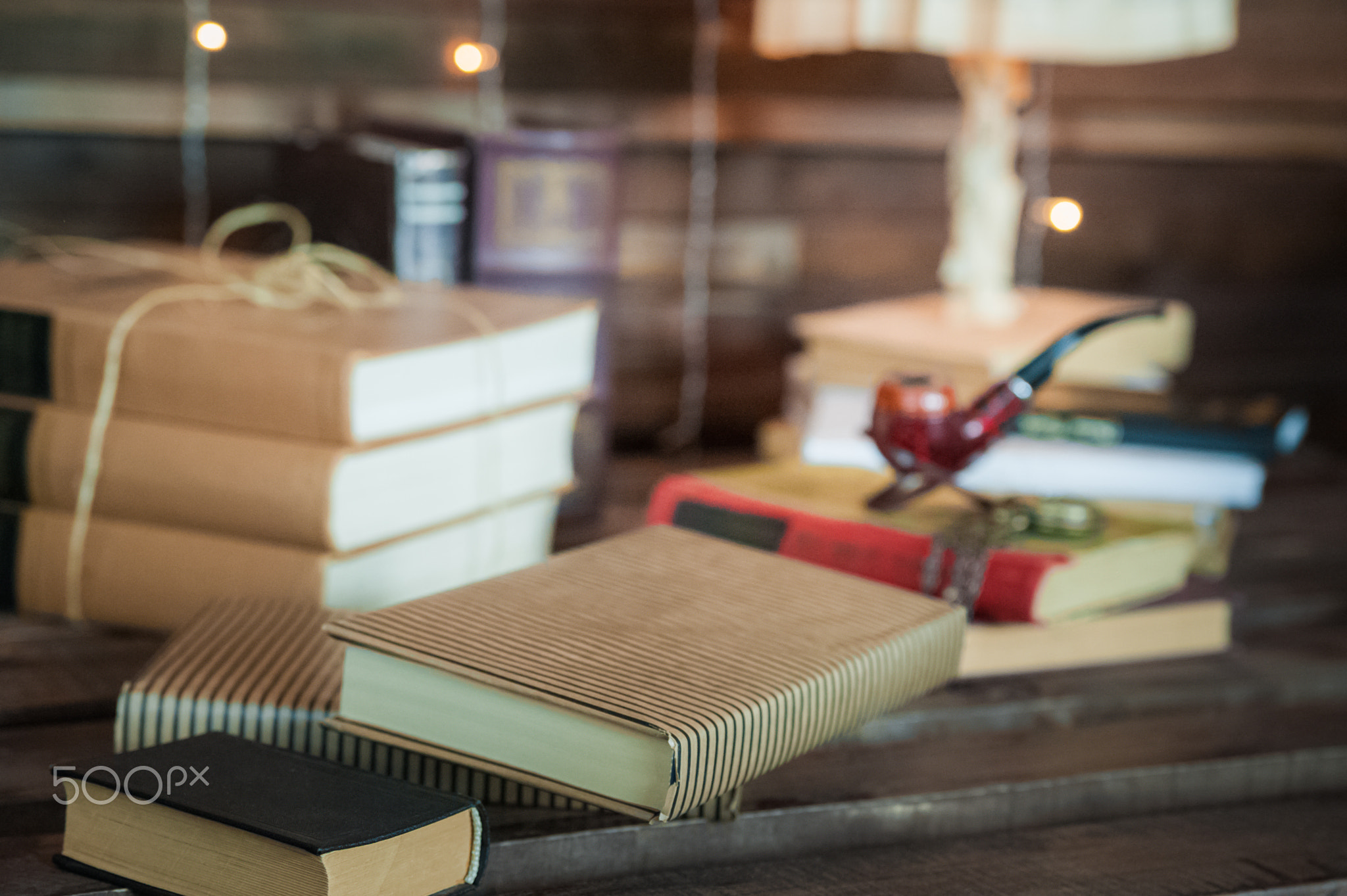 Cabinet in the loft style. Living room in ekostyle. Brown sofas, books and wooden beams