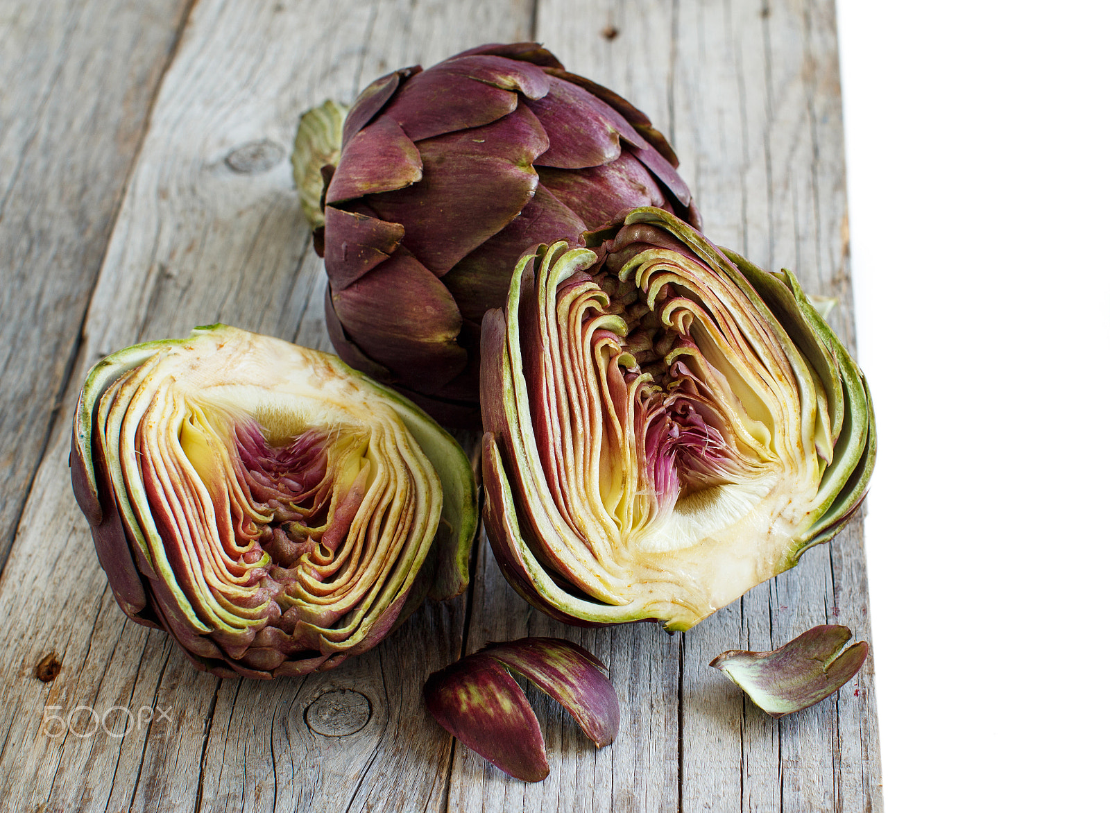 Canon EOS 650D (EOS Rebel T4i / EOS Kiss X6i) + Canon EF 50mm F1.2L USM sample photo. Roman artichokes on a wooden board photography