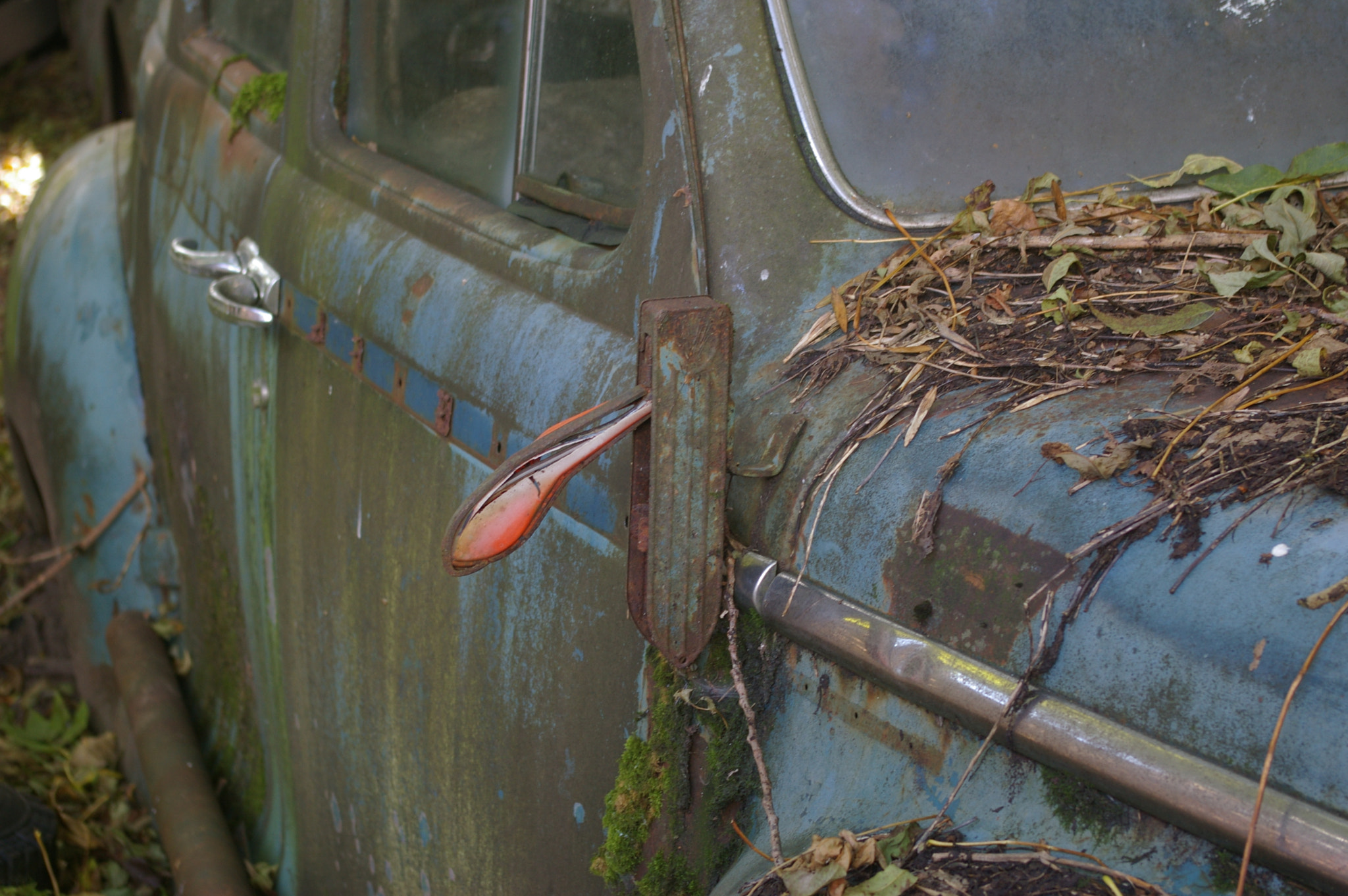 Pentax K100D sample photo. Pointer of a old car at a car graveyard photography