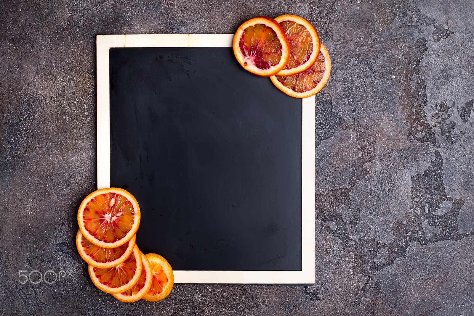 Nikon D610 + AF Nikkor 50mm f/1.8 sample photo. Orange rings on a black chalkboard. photography