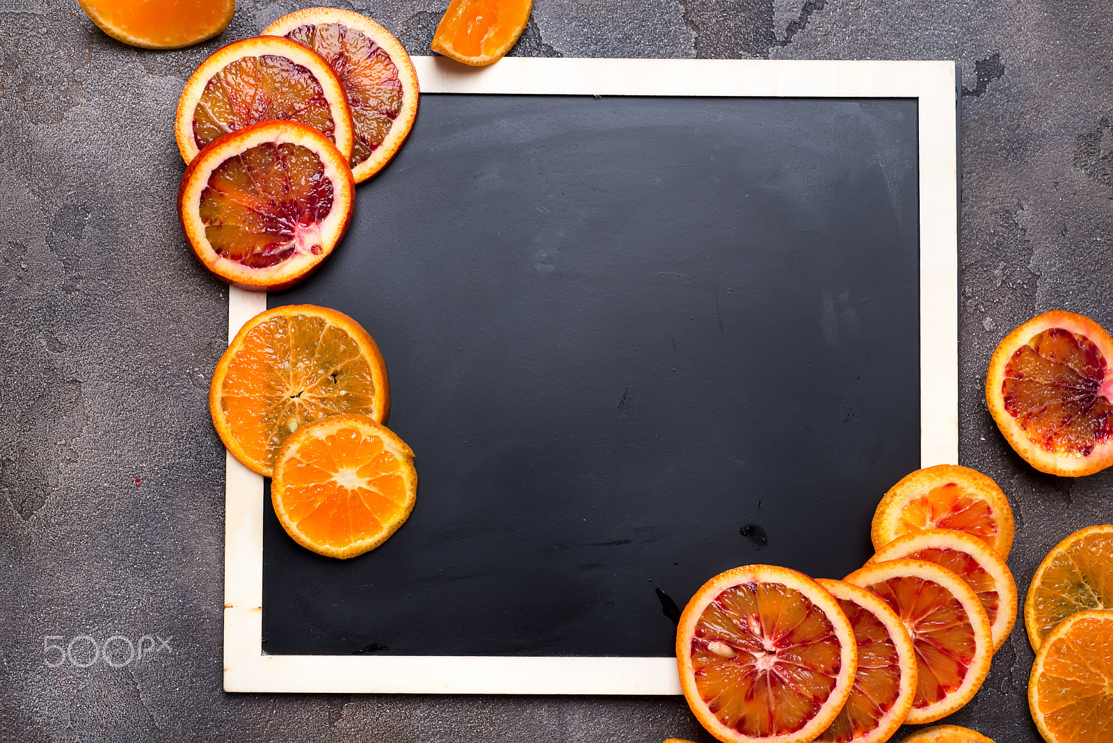 Nikon D610 + AF Nikkor 50mm f/1.8 sample photo. Orange rings on a black chalkboard. photography