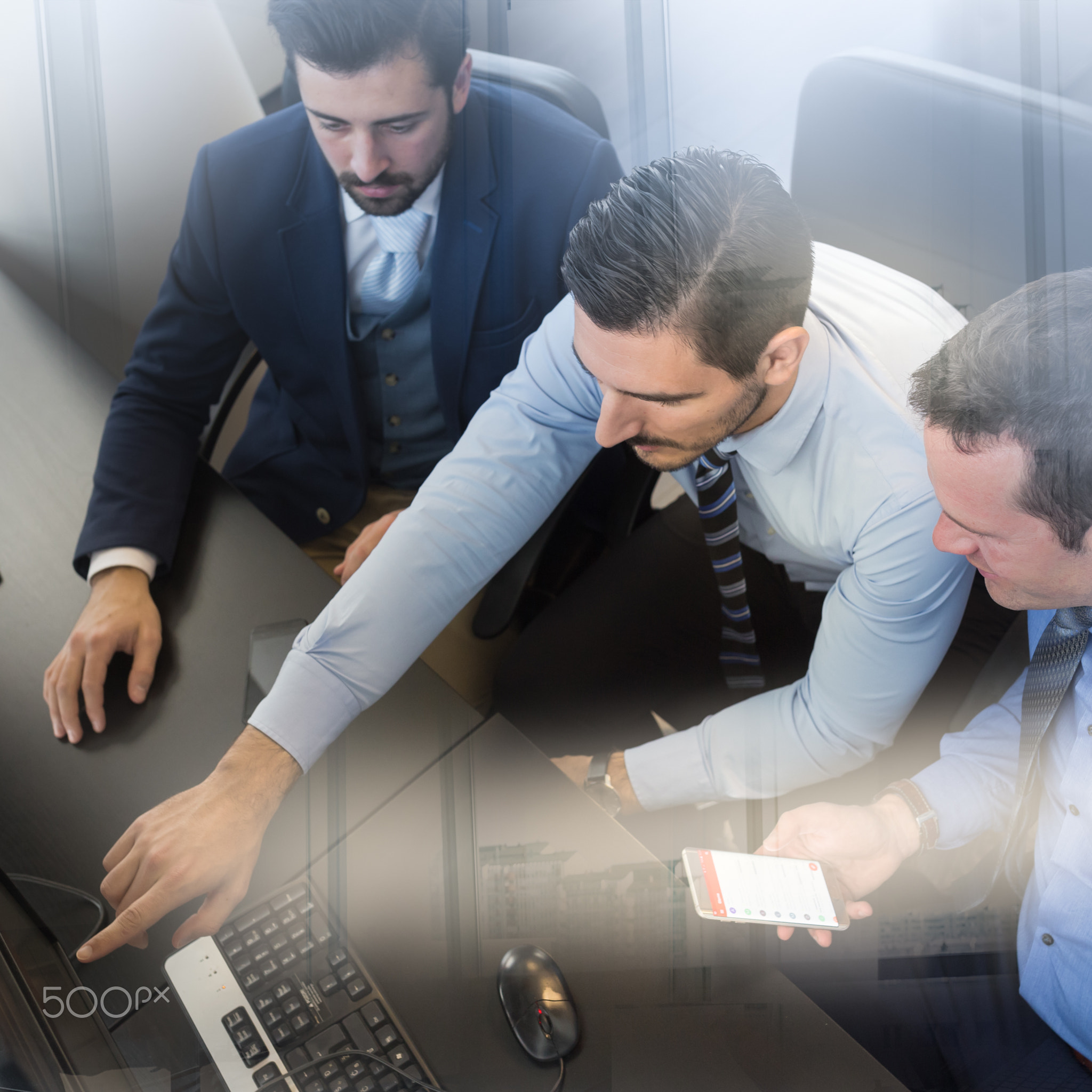Business team analyzing data on computer.