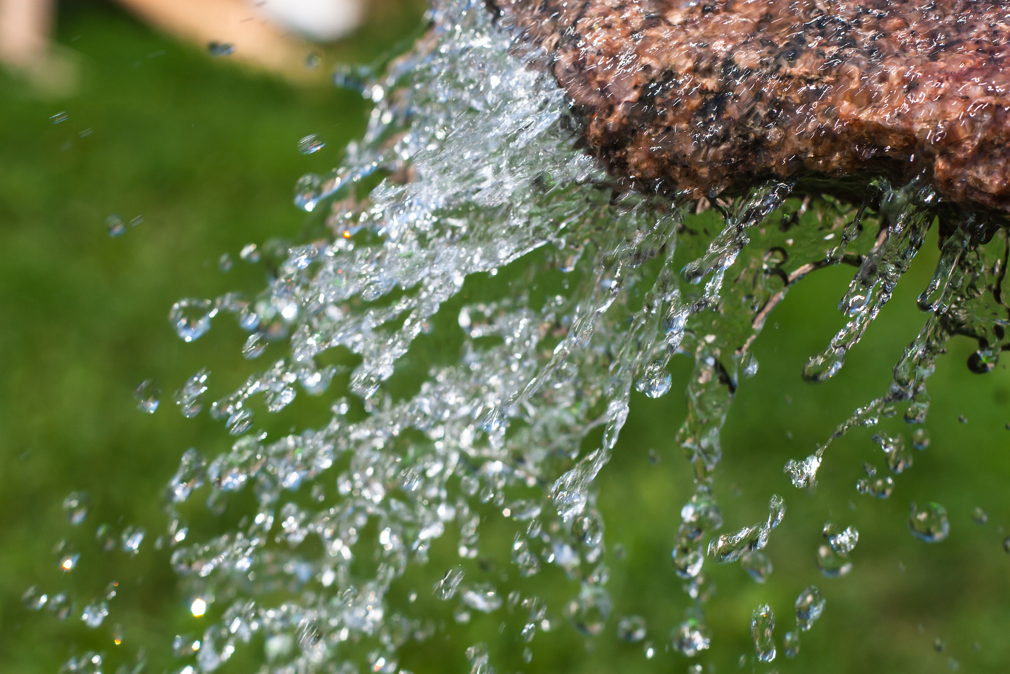 Canon EOS 30D + Canon EF 50mm f/1.8 sample photo. Water dripping from a piece of red granite photography