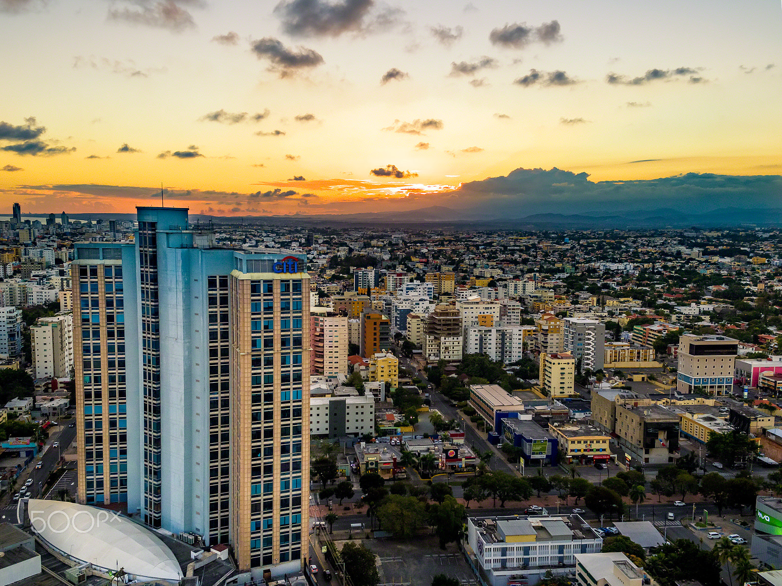 DJI MFT 15mm F1.7 ASPH sample photo. Sunset over downtown santo domingo photography