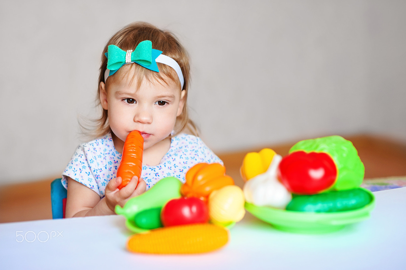Nikon D700 + Nikon AF Nikkor 85mm F1.8D sample photo. Little girl is playing at the table with vegetables. child vegetarian. concept of healthy eating photography