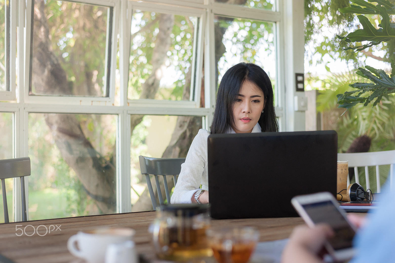 Nikon D700 + Nikon AF-S Nikkor 50mm F1.8G sample photo. Young asian woman working with laptop in coffee shop photography