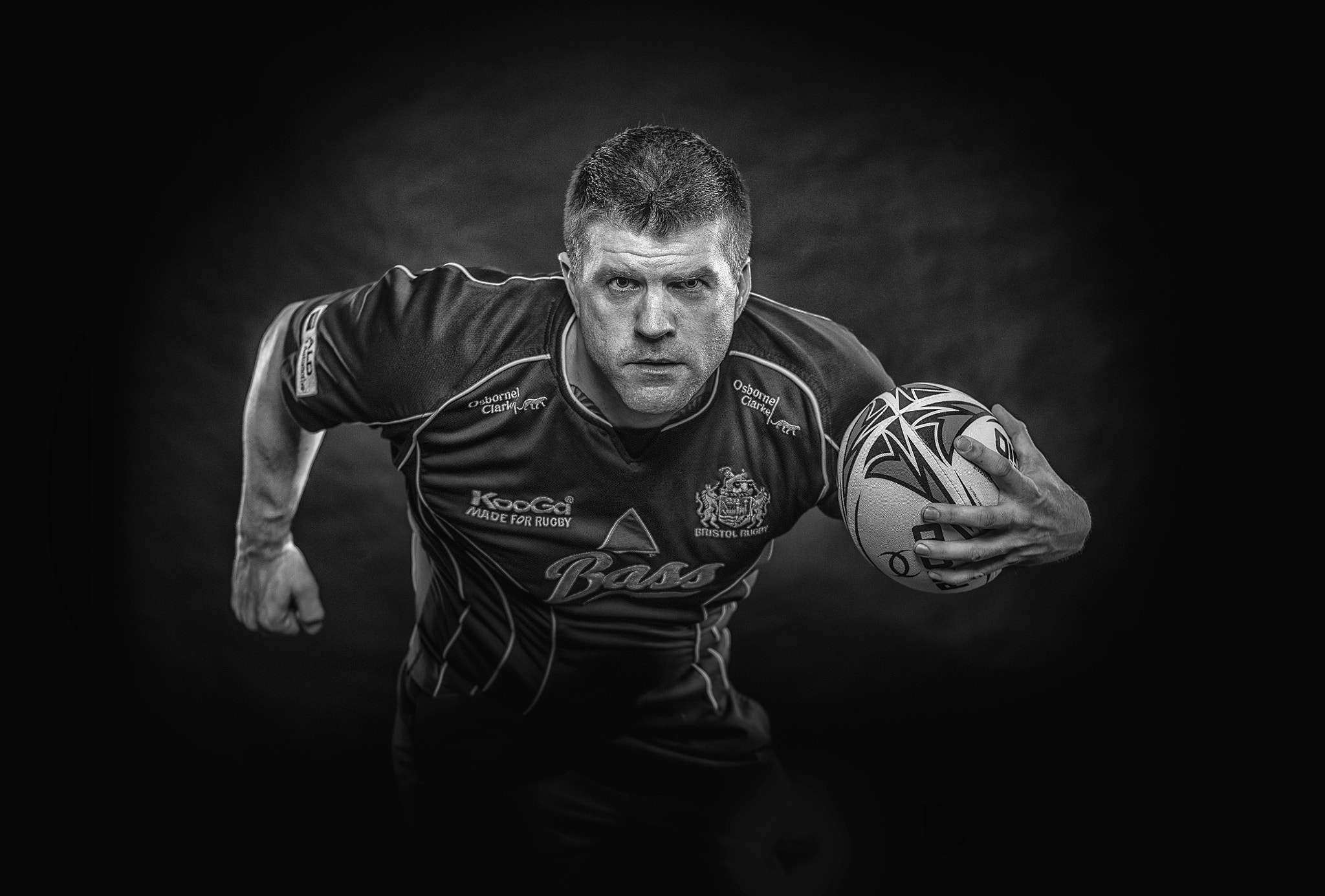 Nikon D810 + Nikon AF-S Nikkor 50mm F1.4G sample photo. A simple back and white image of a rugby star. photography