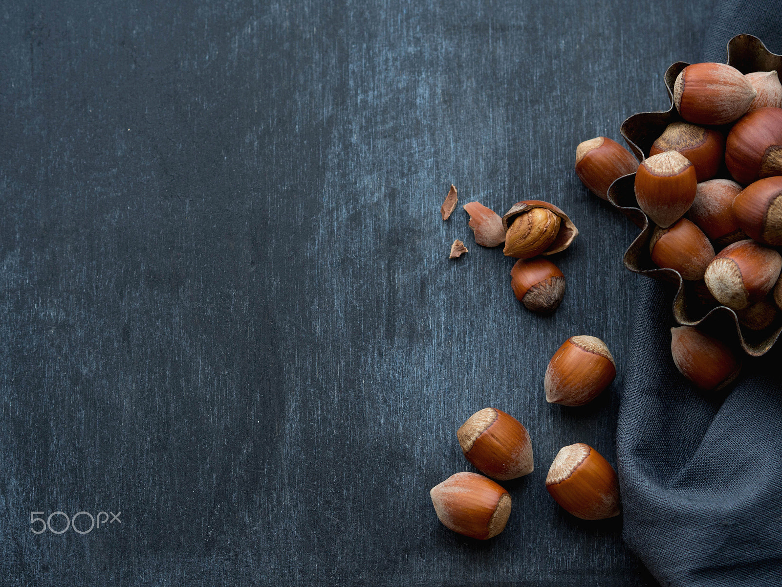 Olympus OM-D E-M10 sample photo. Hazelnuts on a dark background photography