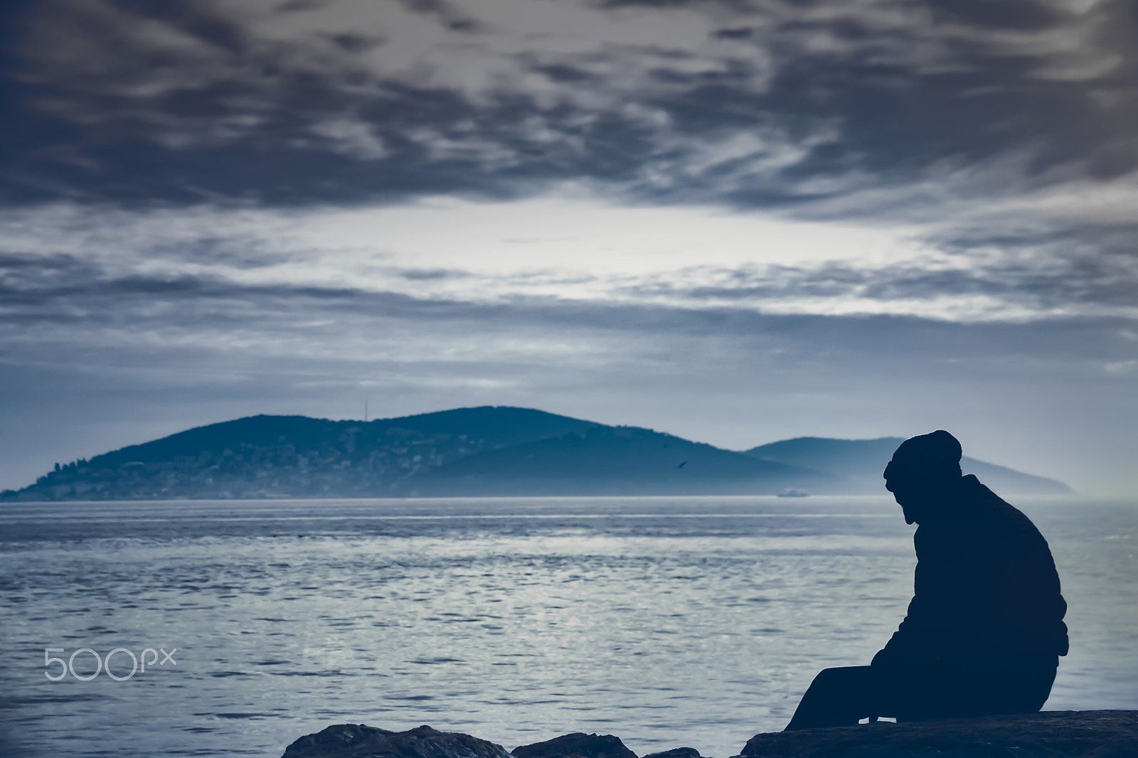 Sigma 18-250mm F3.5-6.3 DC Macro OS HSM sample photo. Man sitting taking photos on mist on sea; travel concept, mornin photography
