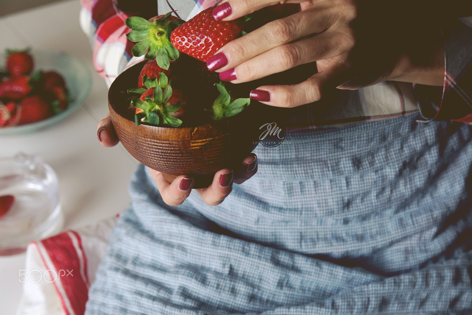 Nikon D7100 sample photo. Woman sitting with bowl of strawberries in hand. photography