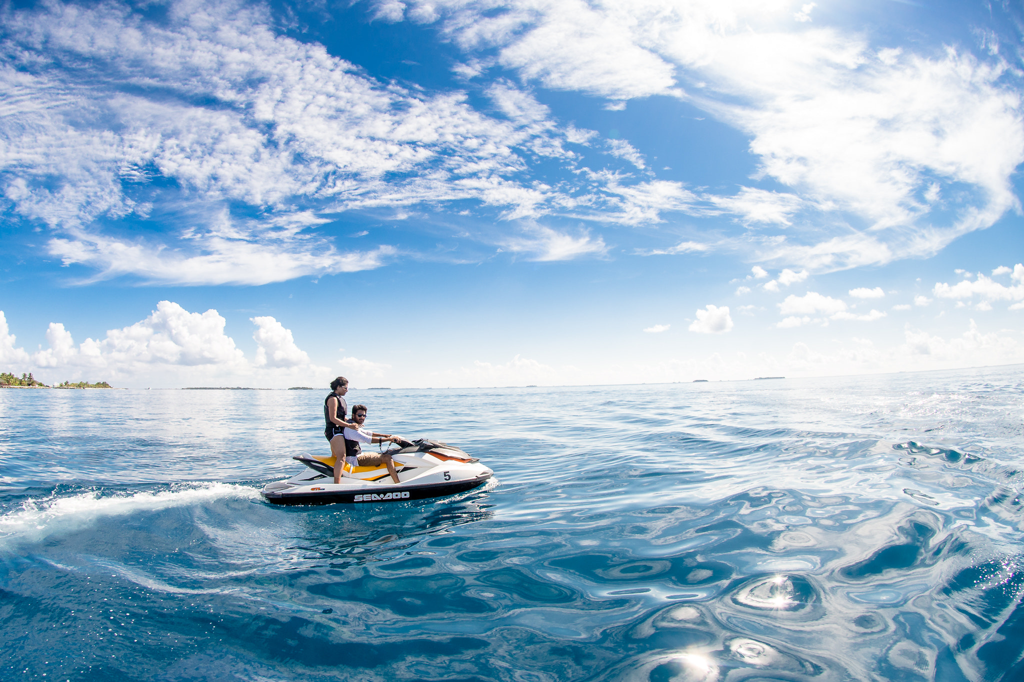 Nikon AF DX Fisheye-Nikkor 10.5mm F2.8G ED sample photo. Couple cruising in maldives on a jetski, photography