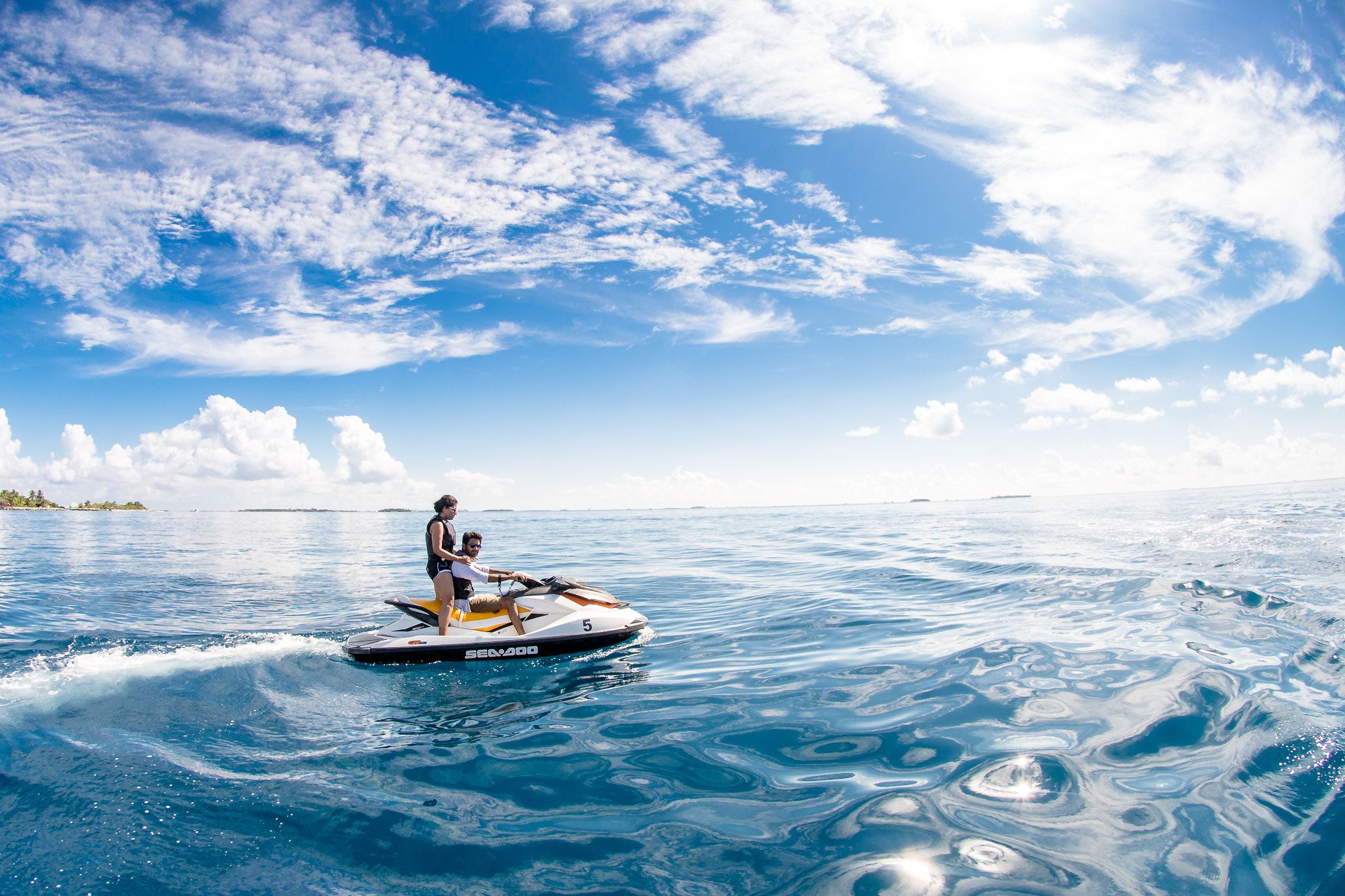 Nikon D610 + Nikon AF DX Fisheye-Nikkor 10.5mm F2.8G ED sample photo. Couple cruising in maldives on a jetski, photography