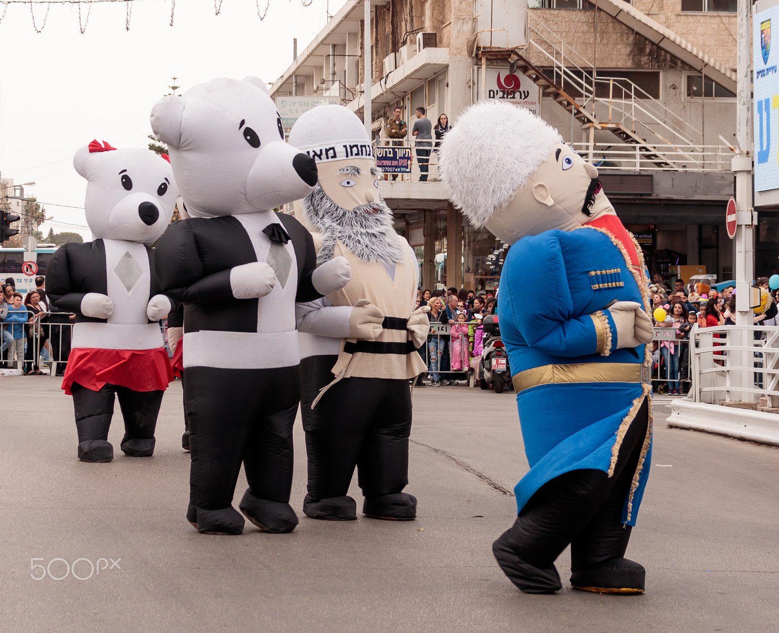 Canon EF 75-300mm F4.0-5.6 IS USM sample photo. Participants dressed in large inflatable suits are walking along photography