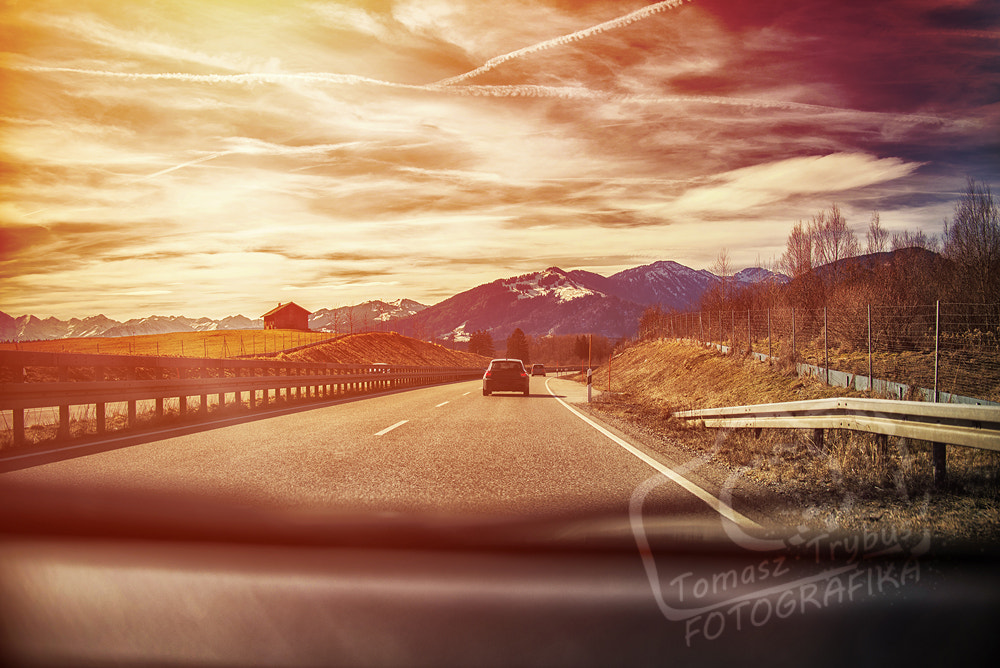 Nikon D610 sample photo. Highway in the alps. view from inside car, sunset or sunrise photography