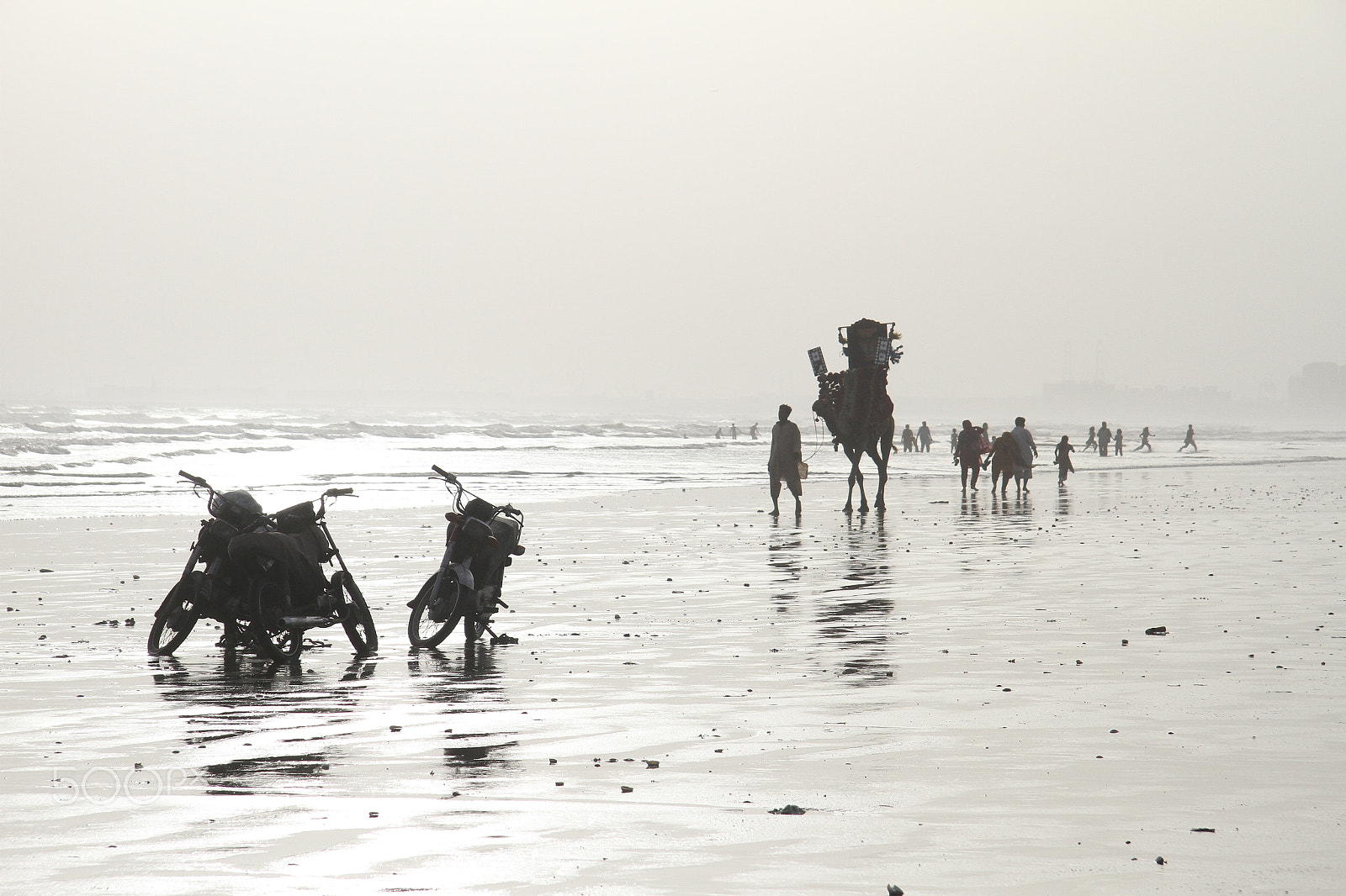 Canon EF-S 17-85mm F4-5.6 IS USM sample photo. Street bikes and camel on beach photography