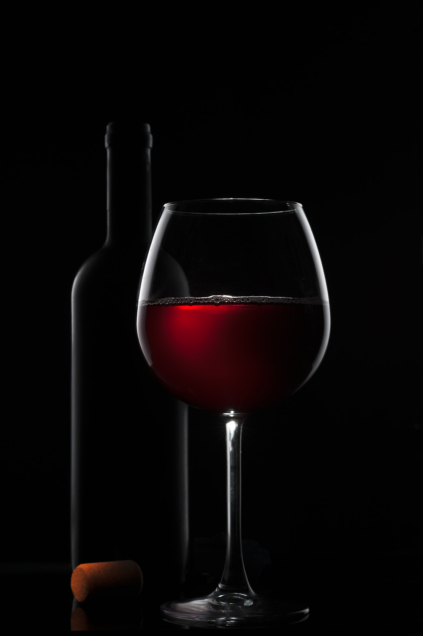 Nikon D3 + Sigma 85mm F1.4 EX DG HSM sample photo. Wine glass and bottle of wine on a dark background photography